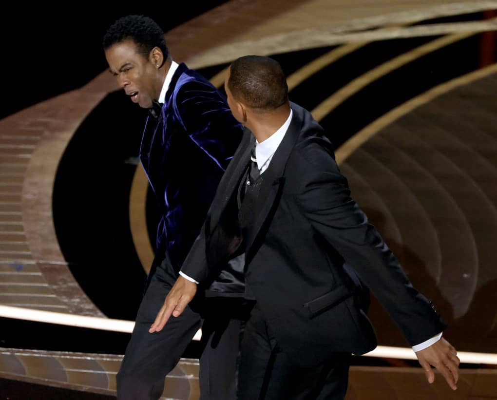 Will Smith hits Chris Rock on stage at the 2022 Academy Awards.