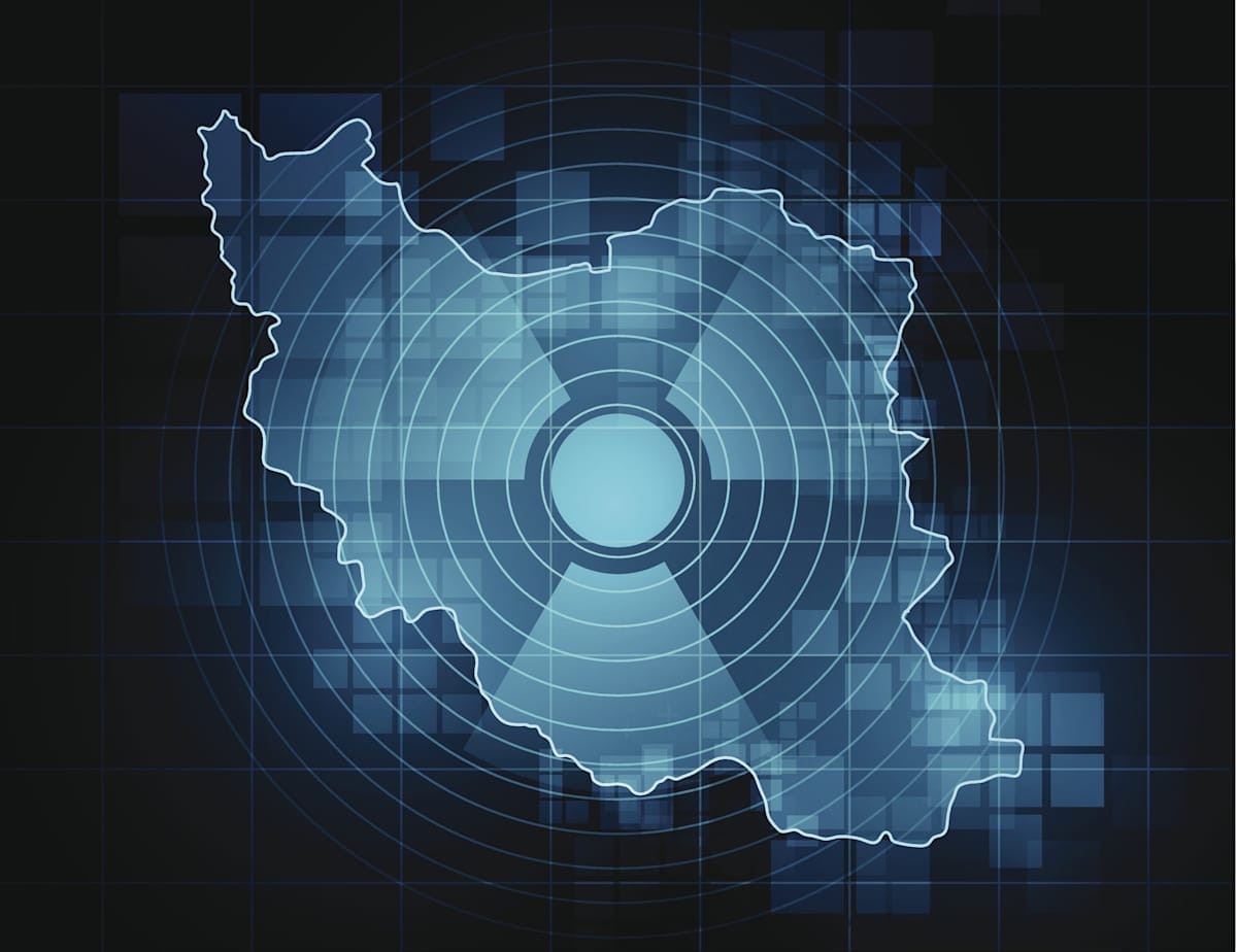 Outline of Iraq map transposed with a nuclear symbol