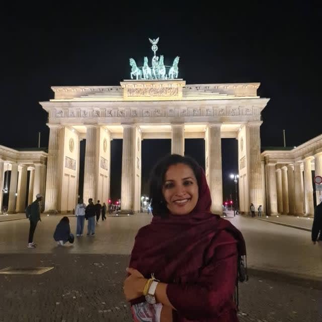 Poovarasi Balan outside the Brandenburg Gate in Germany.