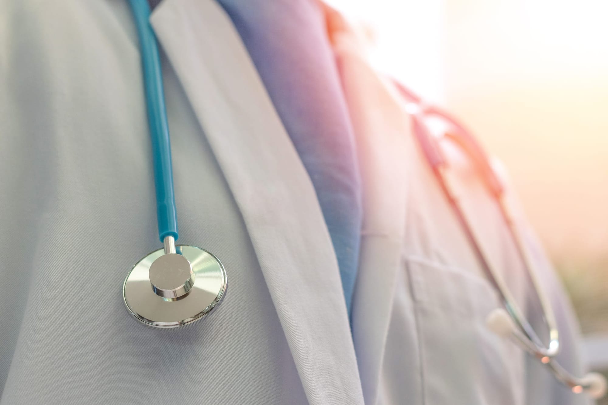 Close-up of the chest of a physician in white coat a with stethoscope in hospital or clinic