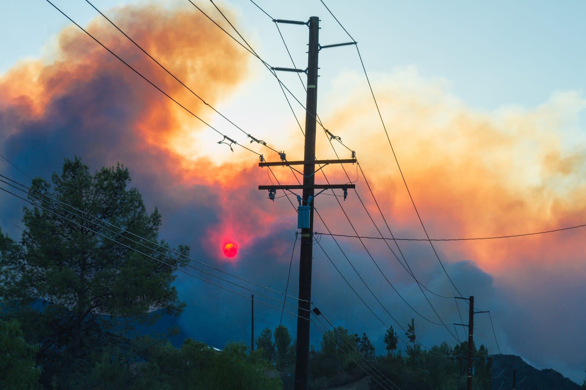 Brush wildfire threatens powerlines.