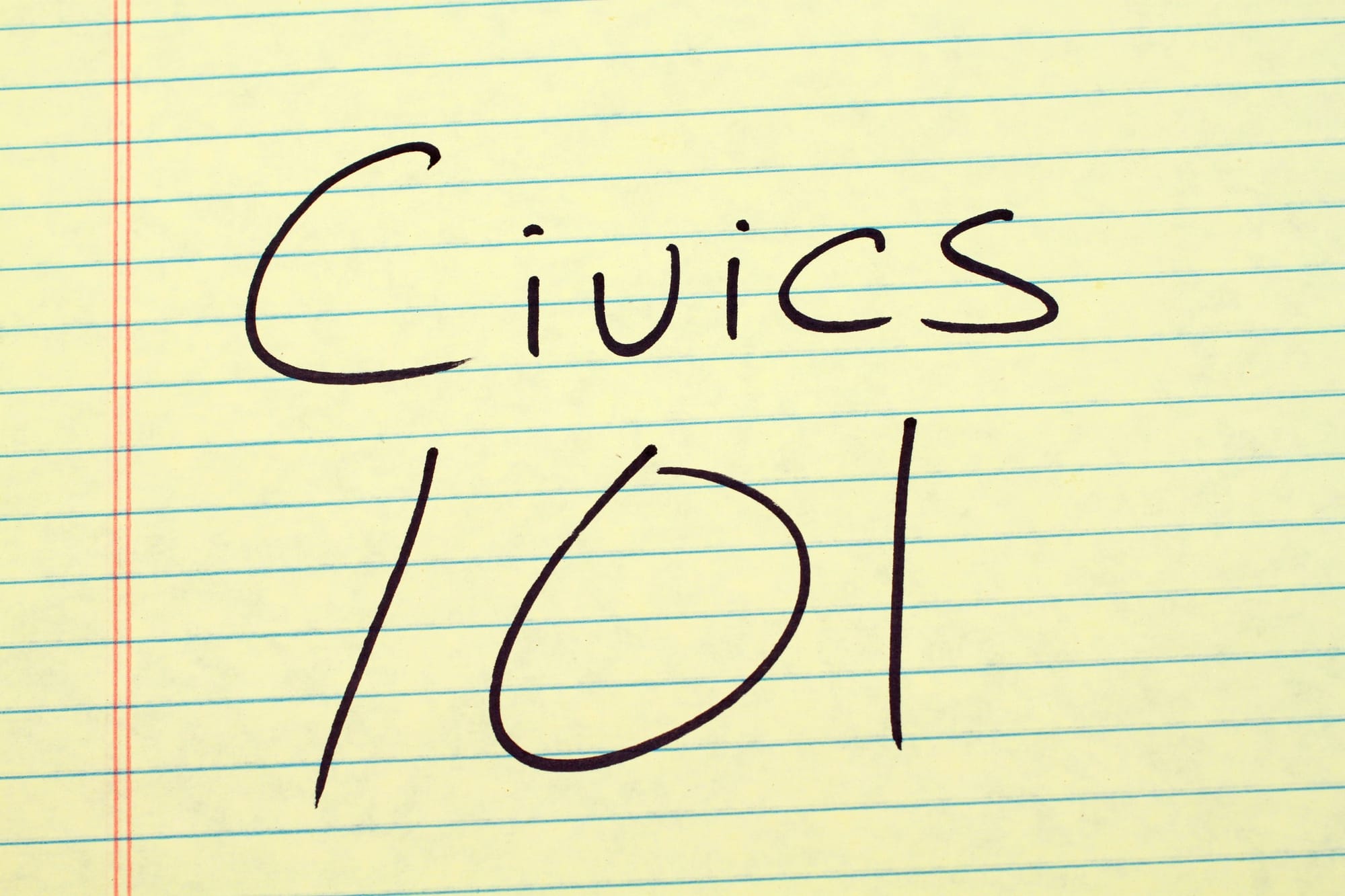 The words "Civics 101" on a yellow legal pad.