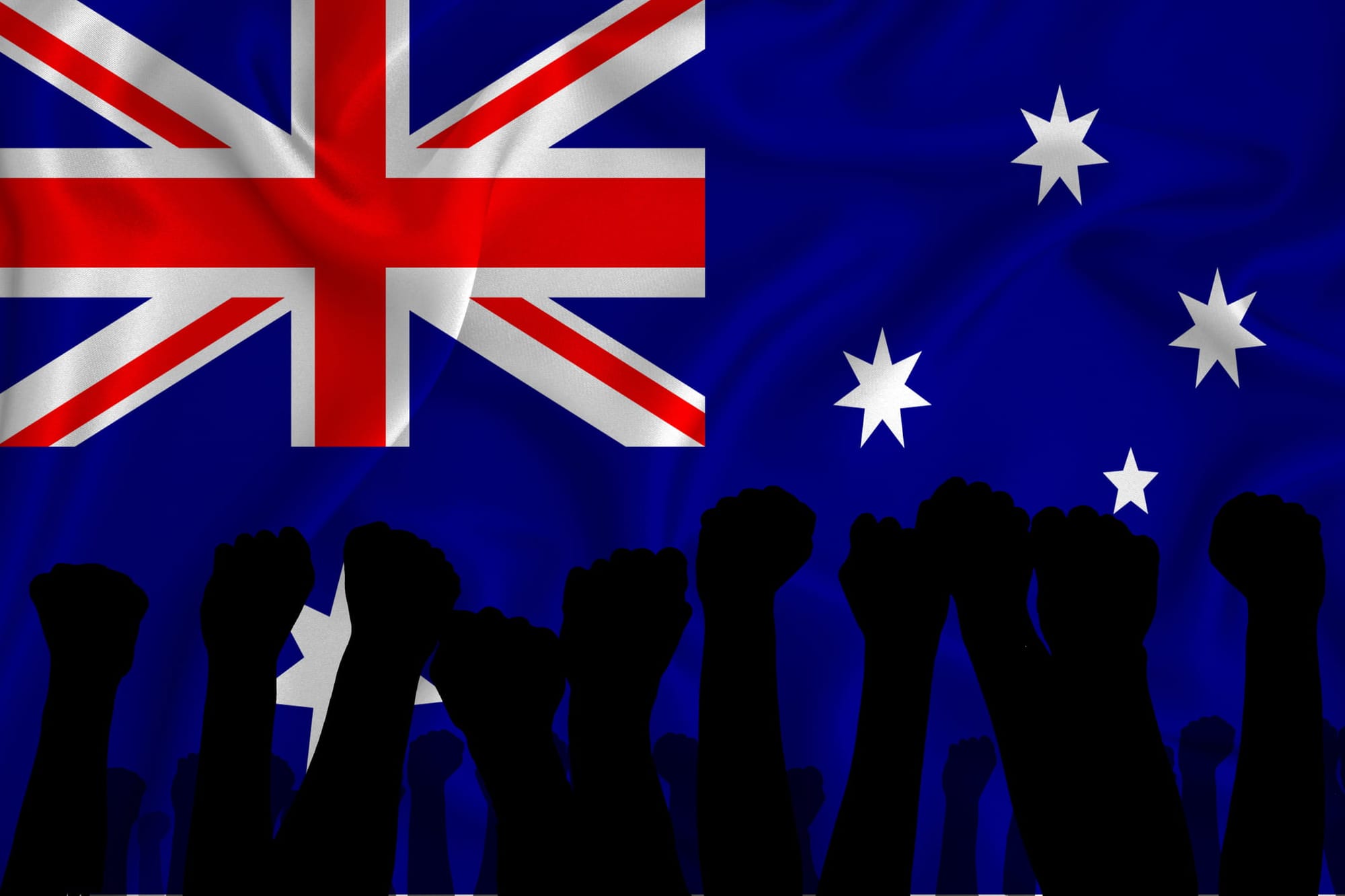 Silhouette of raised arms and clenched fists on the background of the flag of Australia.