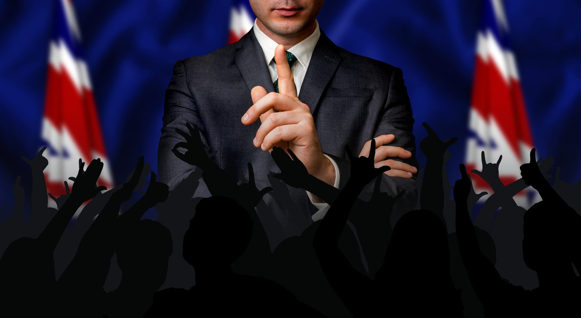 British political candidate speaks to a crowd of people.