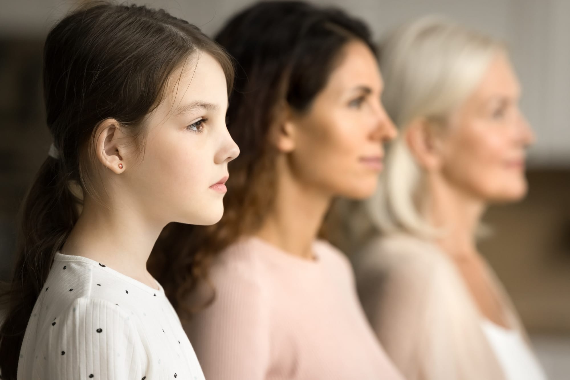 Side shot of young girl with mother and grandmother.