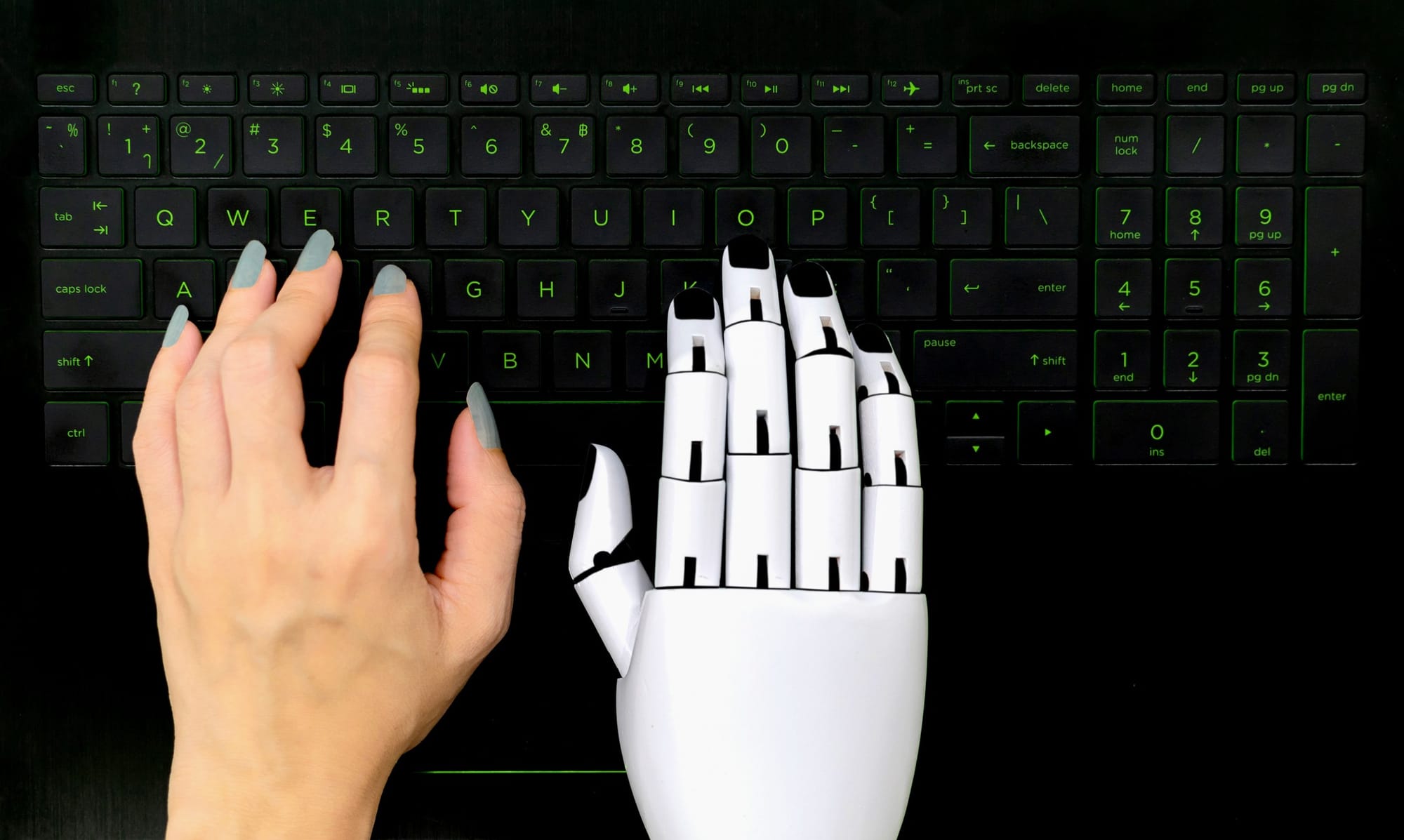 Robot concept chatbot of Human hand and robot hand pressing computer keyboard.