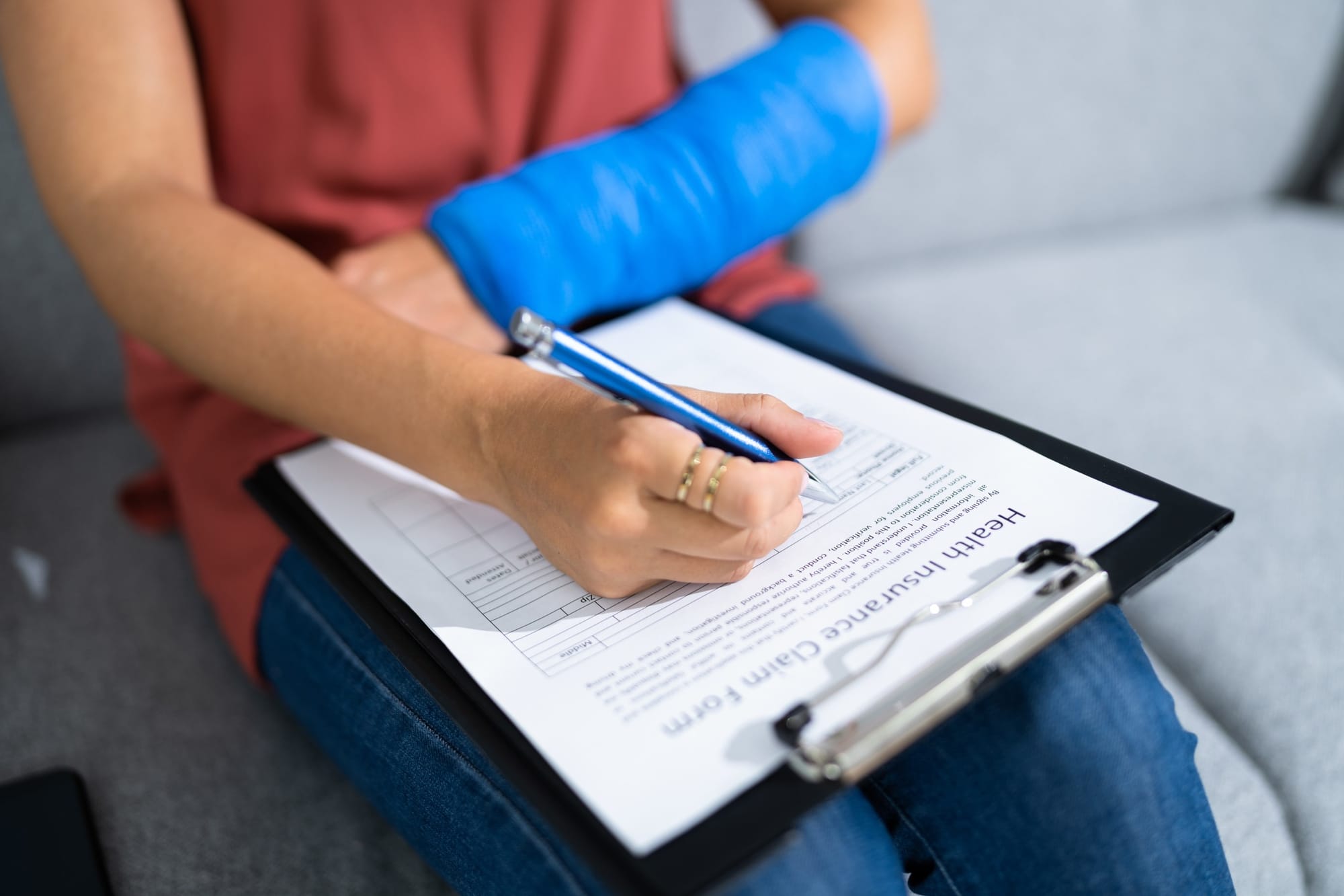 Injured worker fills out a health insurance claim.