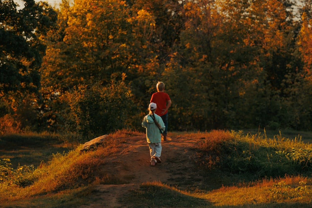 Children walking on a track with trees in the background