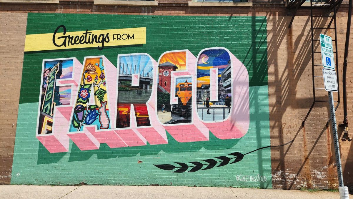 "Greetings from Fargo" postcard-style mural painted on a brick building in downtown Fargo, North Dakota.
