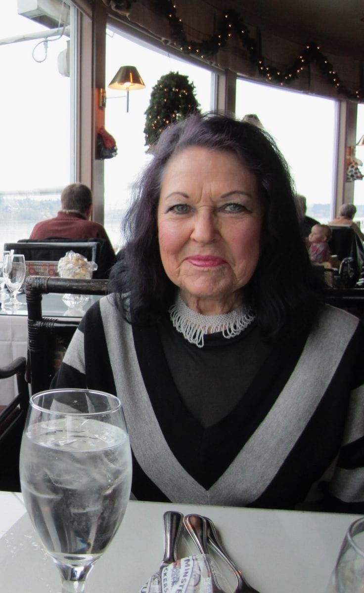My grandmother sitting at dinner.