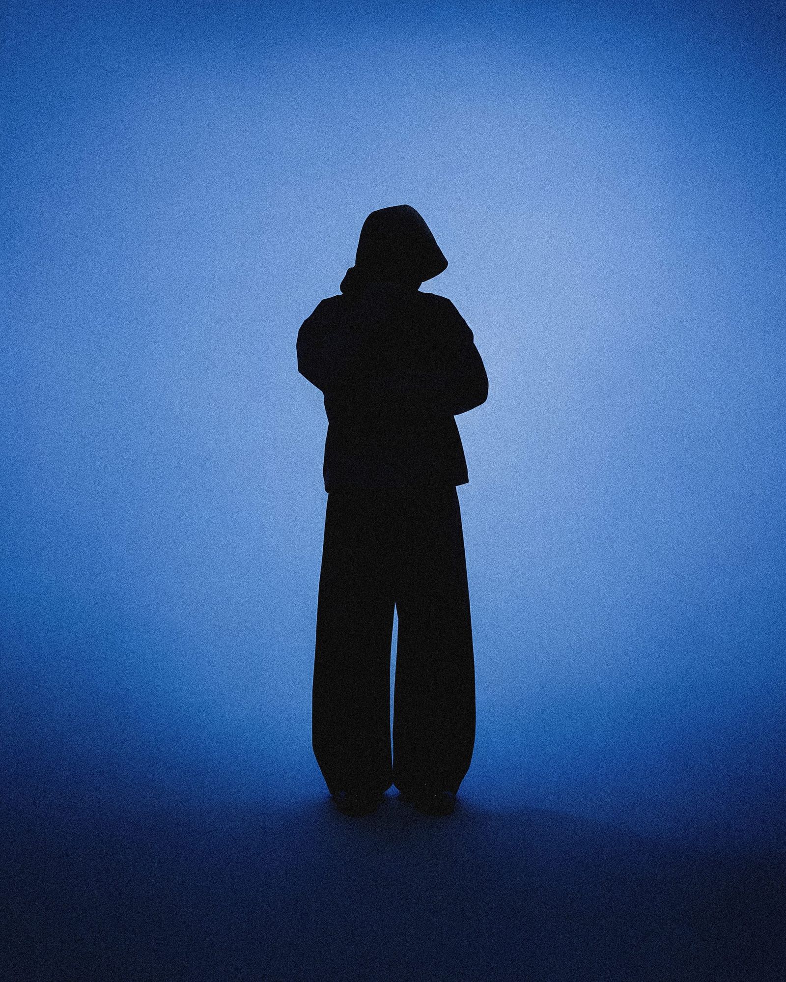 Lone Figure In A Blue Lit Studio
