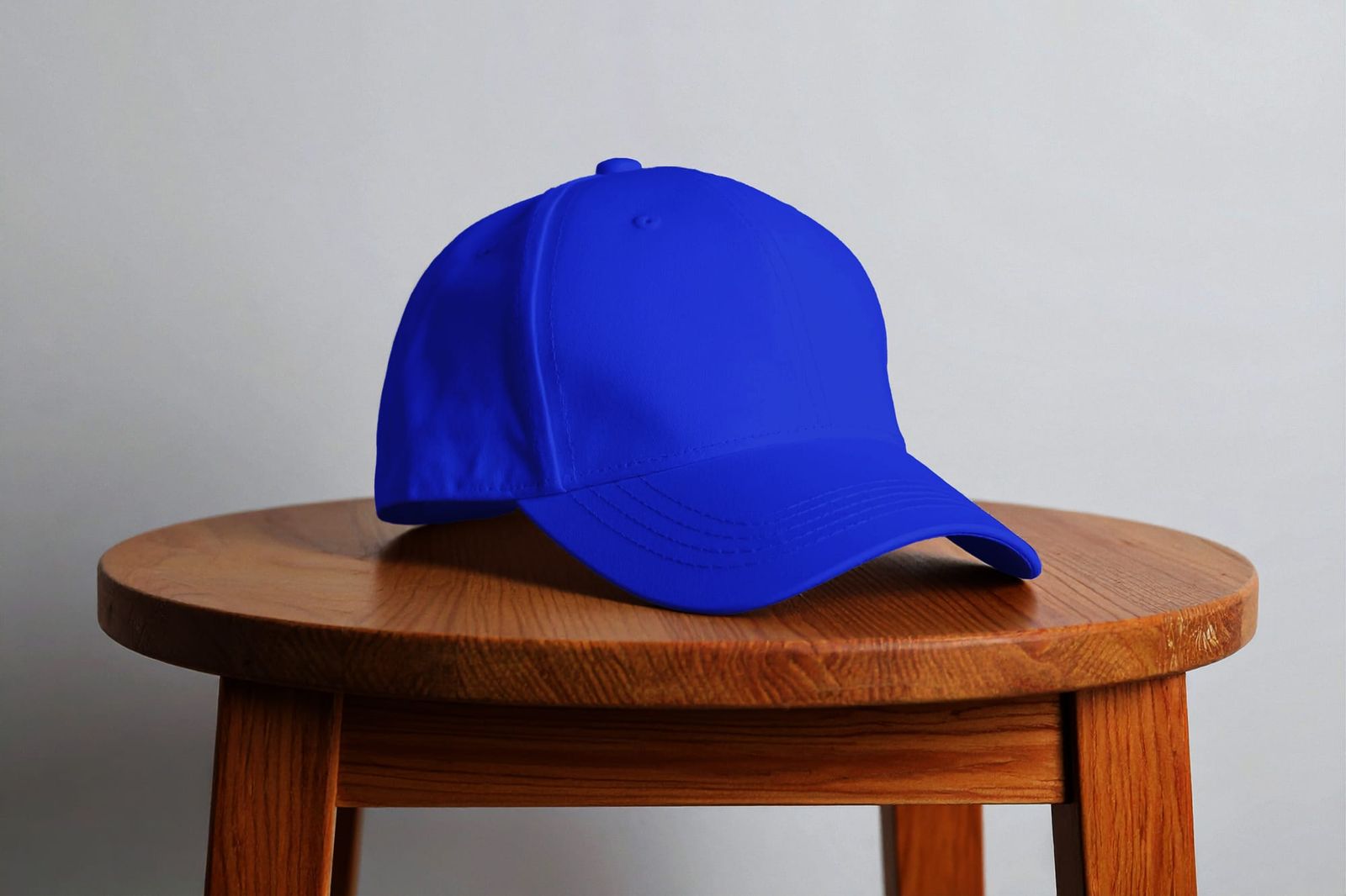 Minimalist Blue Baseball Cap Mockup on Wooden Stool