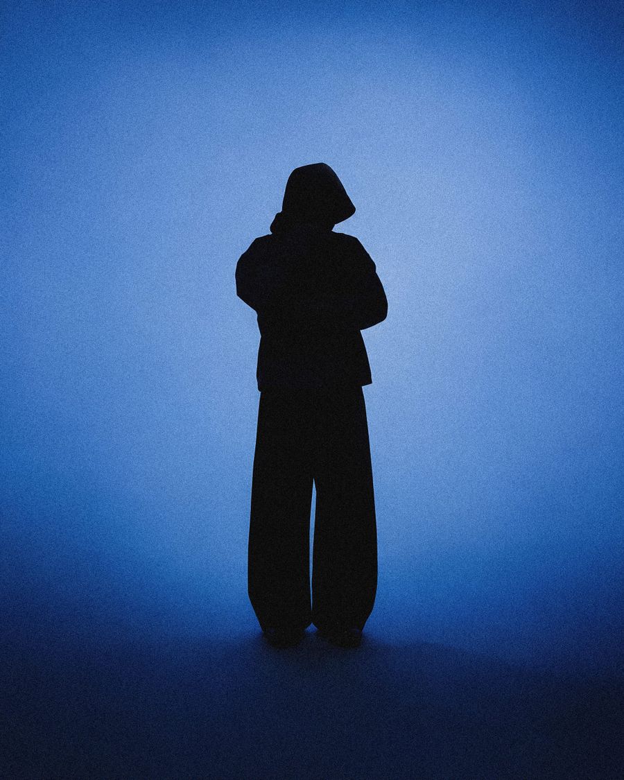 Lone Figure In A Blue Lit Studio