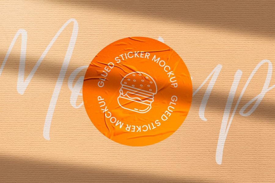 Wrinkled Orange Badge Sticker Mockup with Typography Background