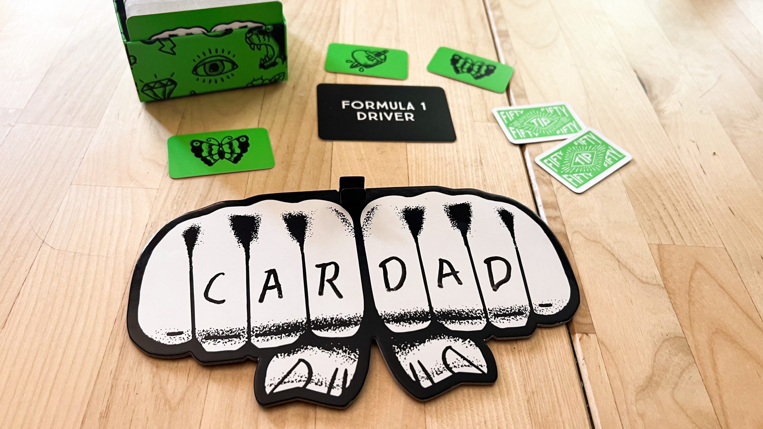 An image showing the fist shaped board that players write their tattoo phrases on