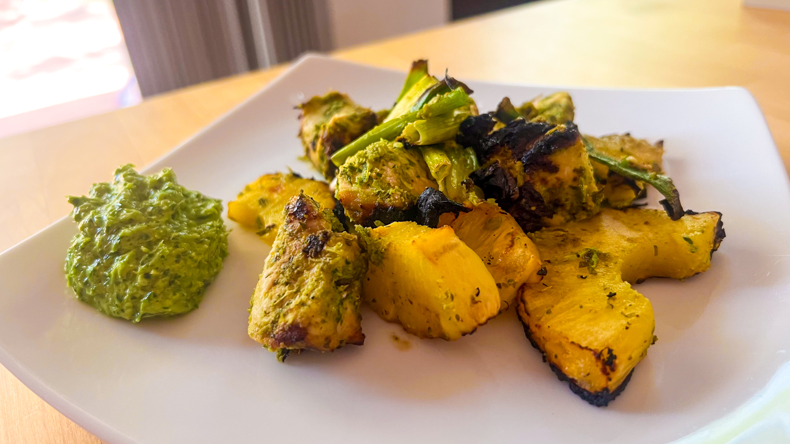 A photo of a chicken and pineapple kebab