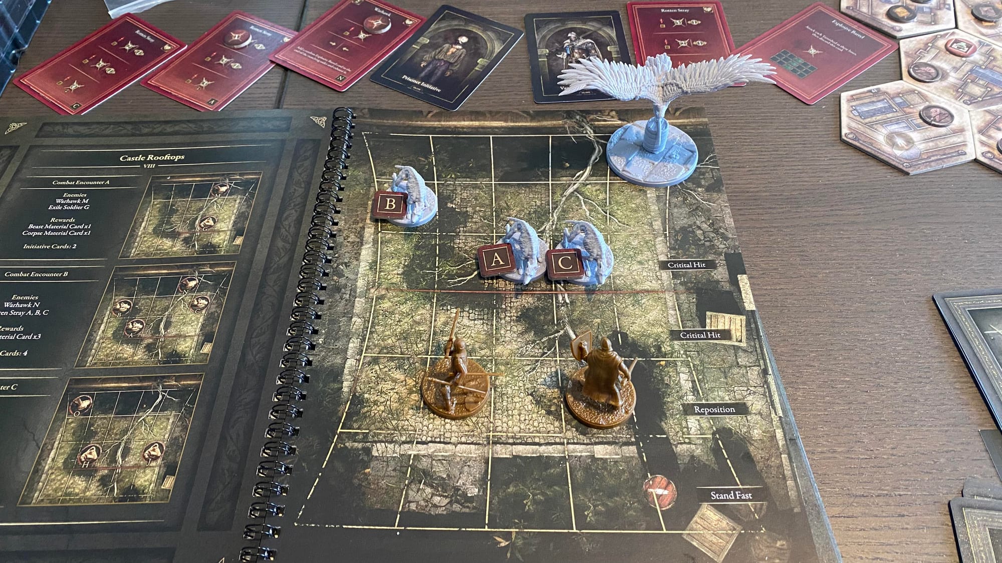 The Tarnished miniatures sit on a gridded map split into two areas, with the other area populated by three Rotten Strays and a Warhawk