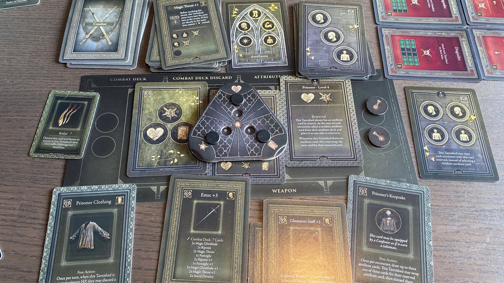 A player board for the Prisoner Tarnished during the final fight of the box, there are lots of cards and upgrades shown.