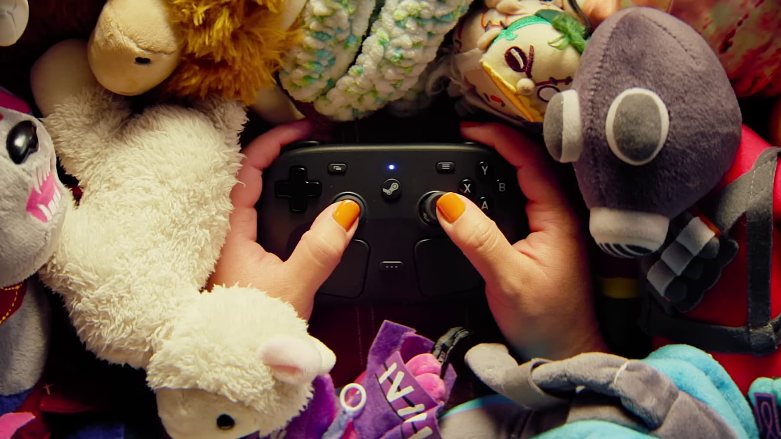 The Steam Controller surrounded by a bunch of plushies