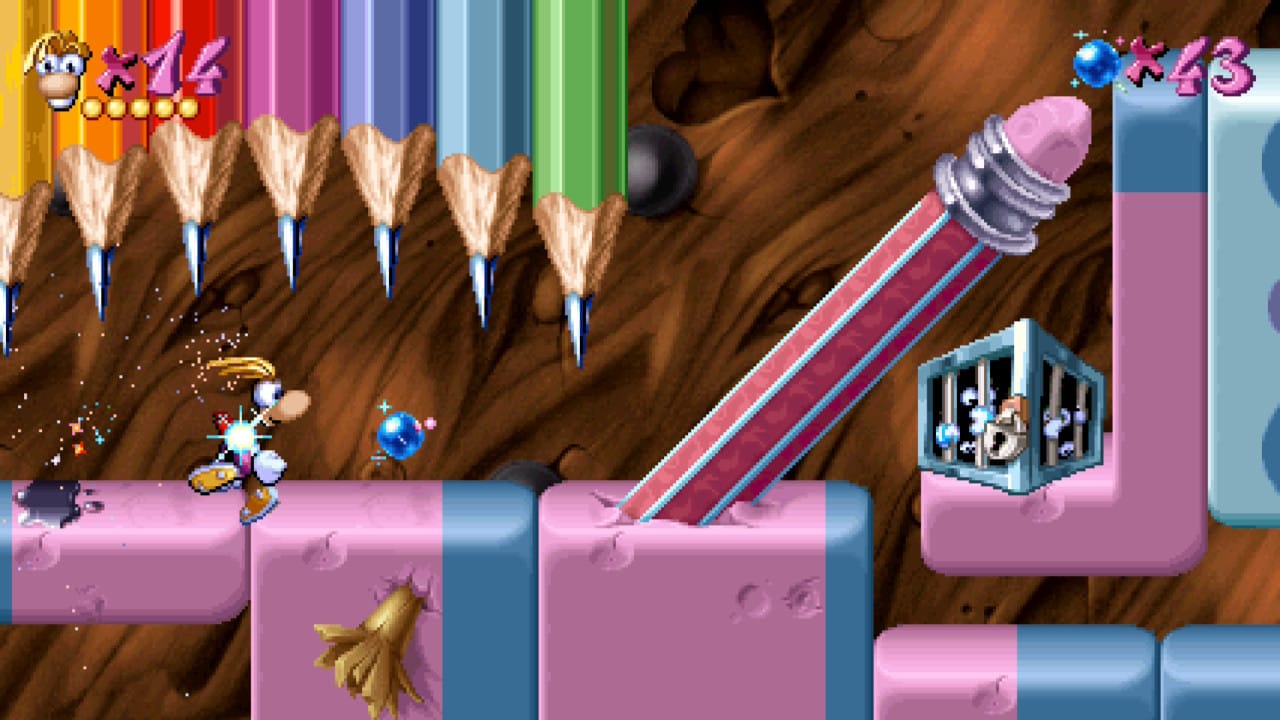 Rayman dashing under some pointy pencils.