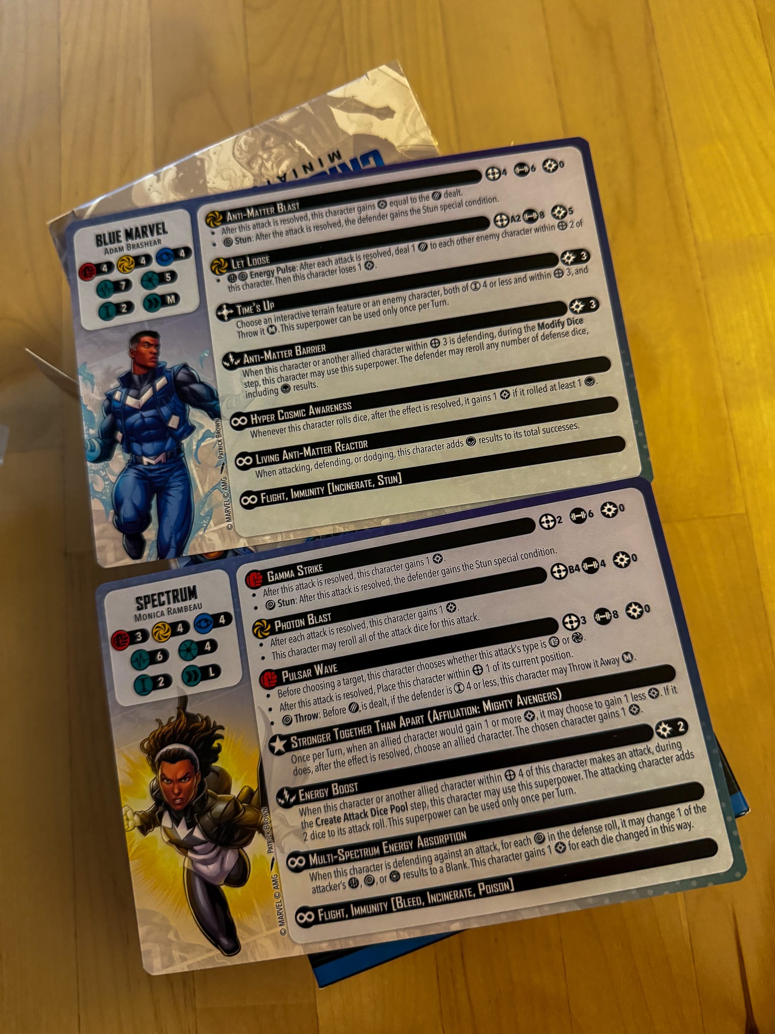 A photo of Marvel Crisis Protocol Blue Marvel and Spectrum character cards