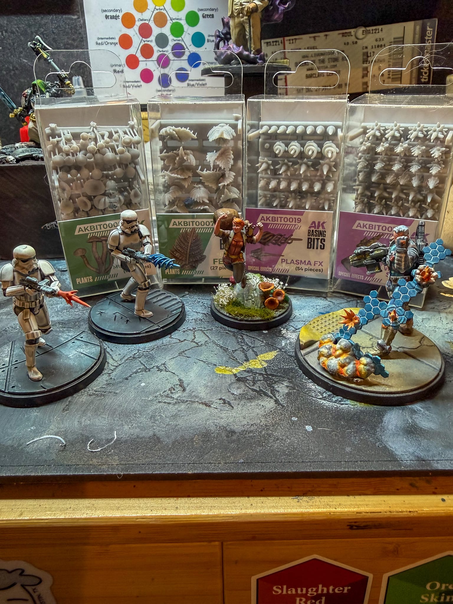 A photo of AK Interactive Basing Bits and some models with the bits being used