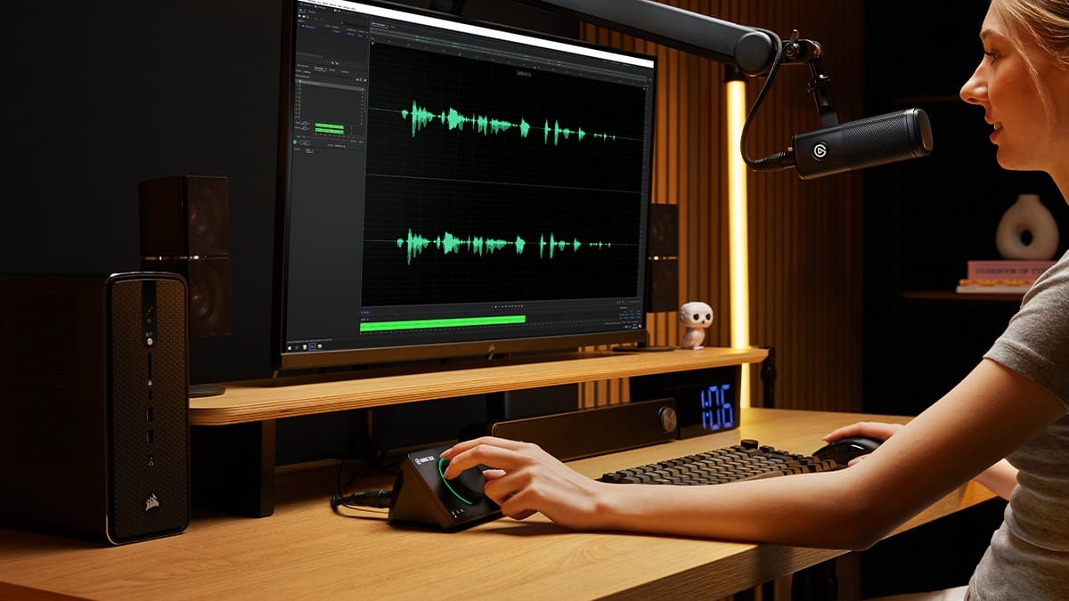 A person adjusting audio levels with a knob-like device.