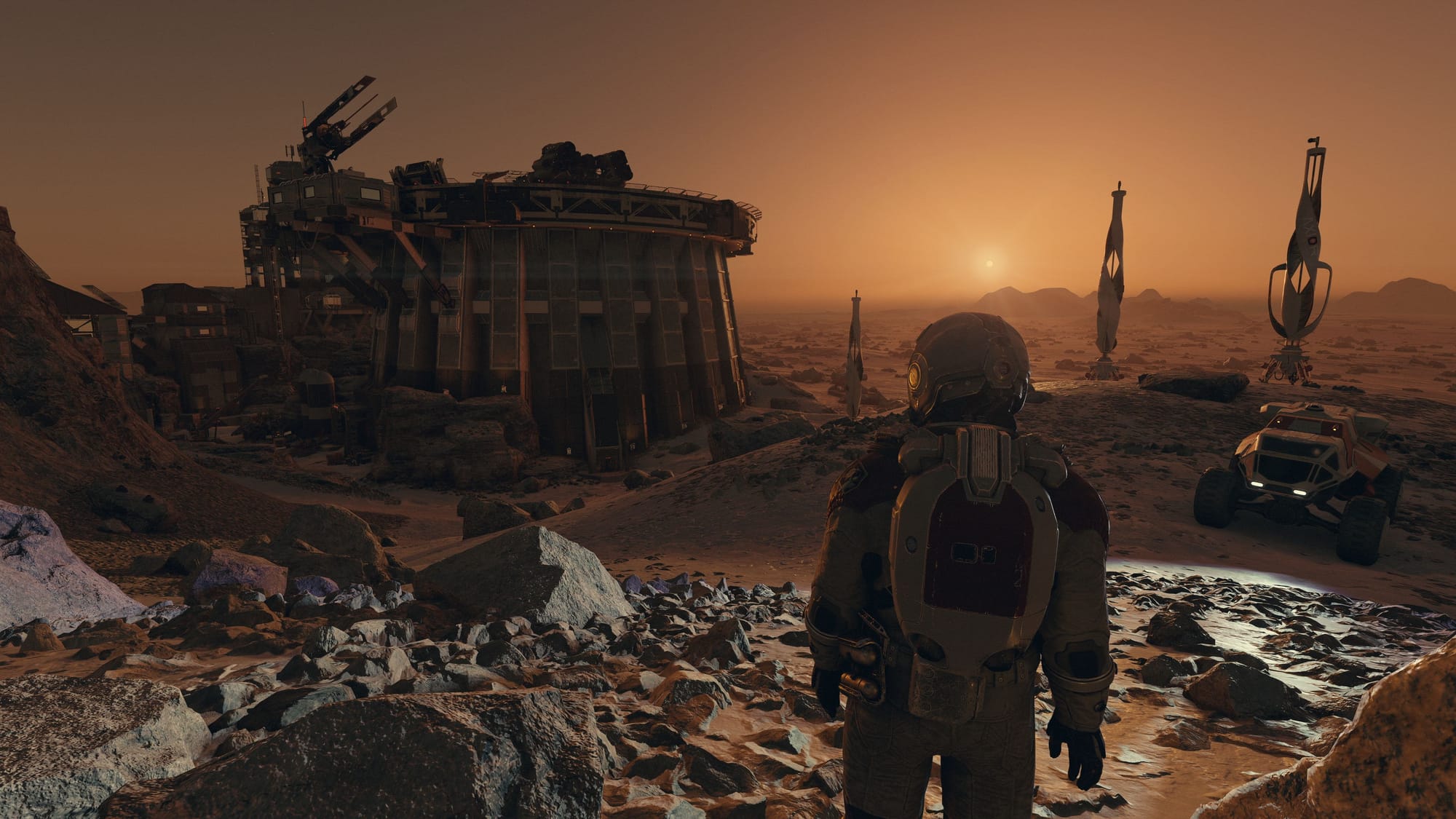 The player in a spacesuit overlooking a sunset on an alien world. 