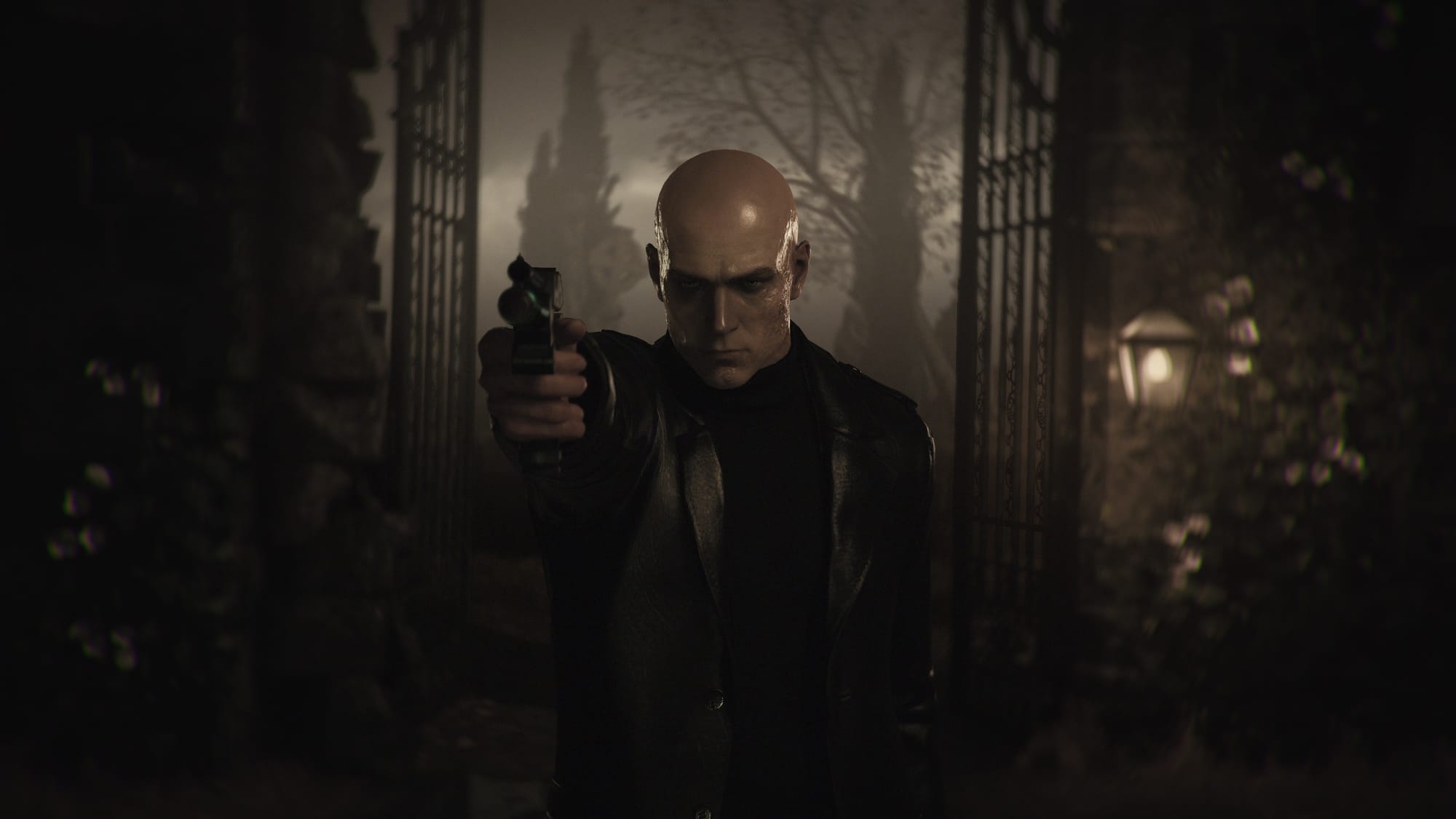 Agent 47 points a gun at the camera.