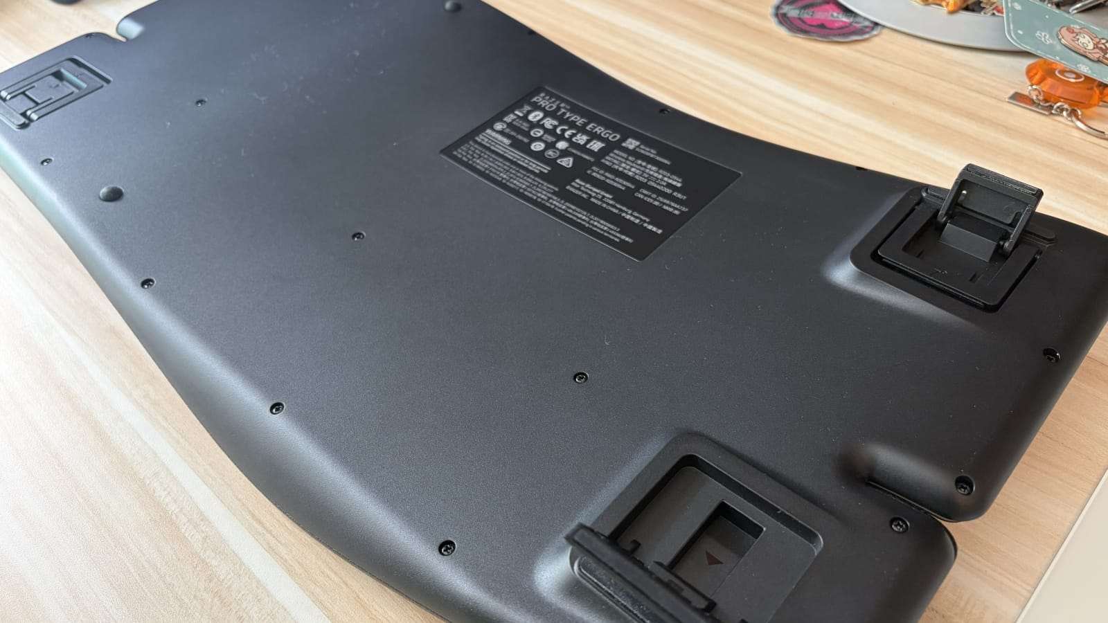 The bottom of the keyboard, the wireless dongle can fit inside one of the kickstands. 