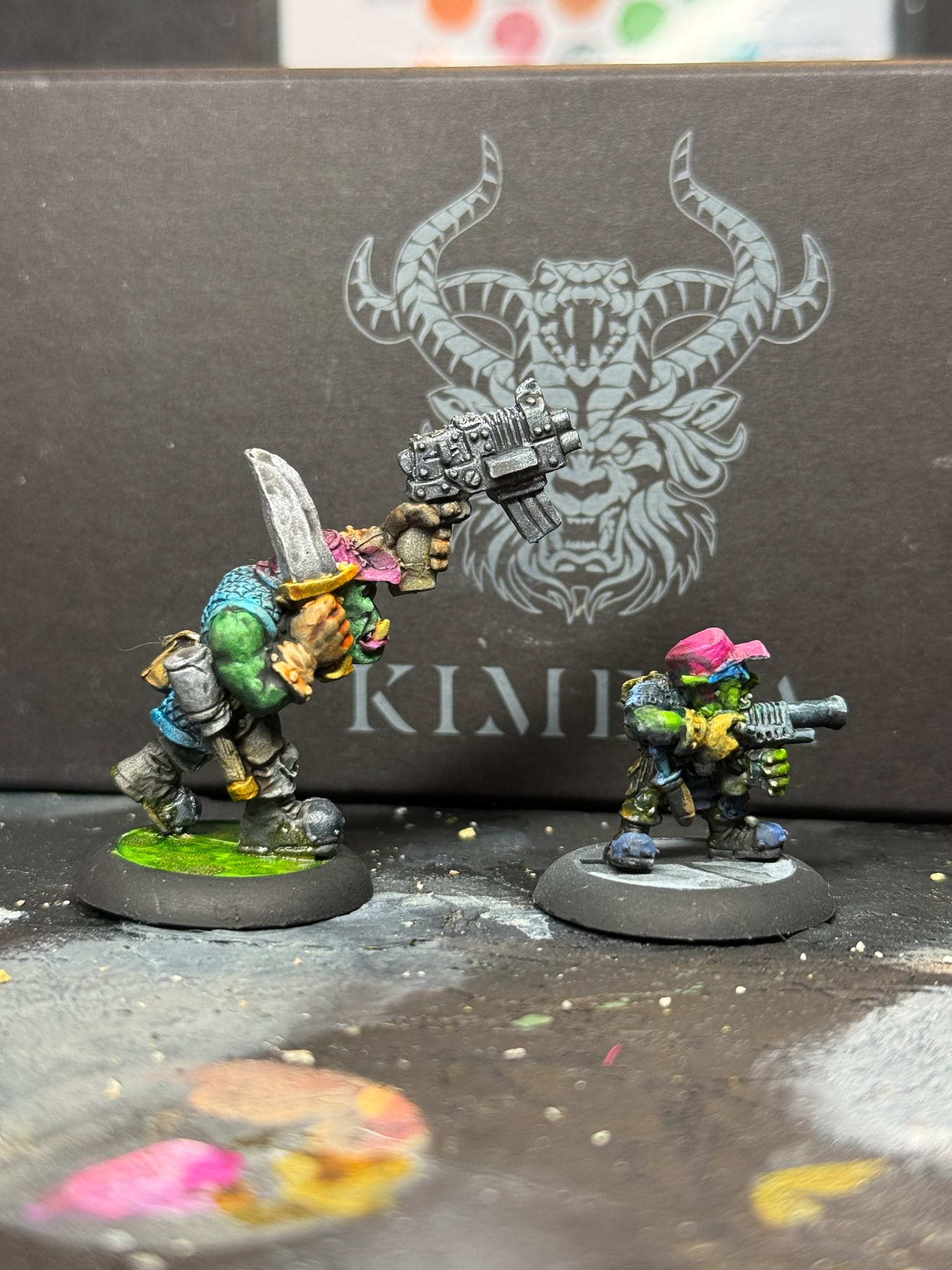 A photo of 2 goblin models, one painted with Kimera paint
