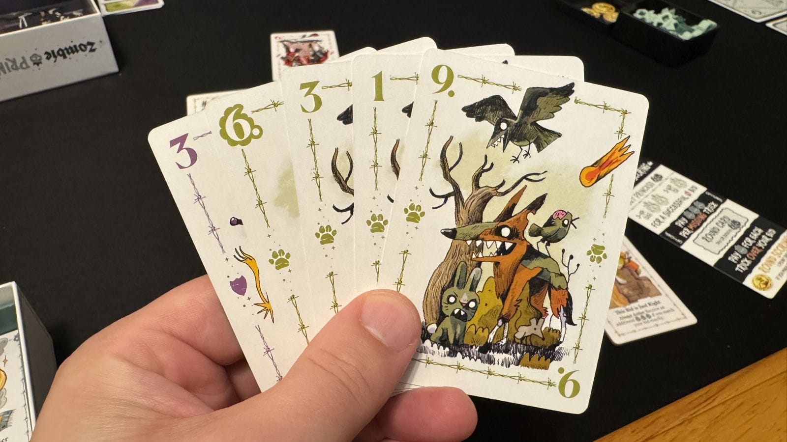 A hand of cards showing off the artwork for the Zombie Pet suit.