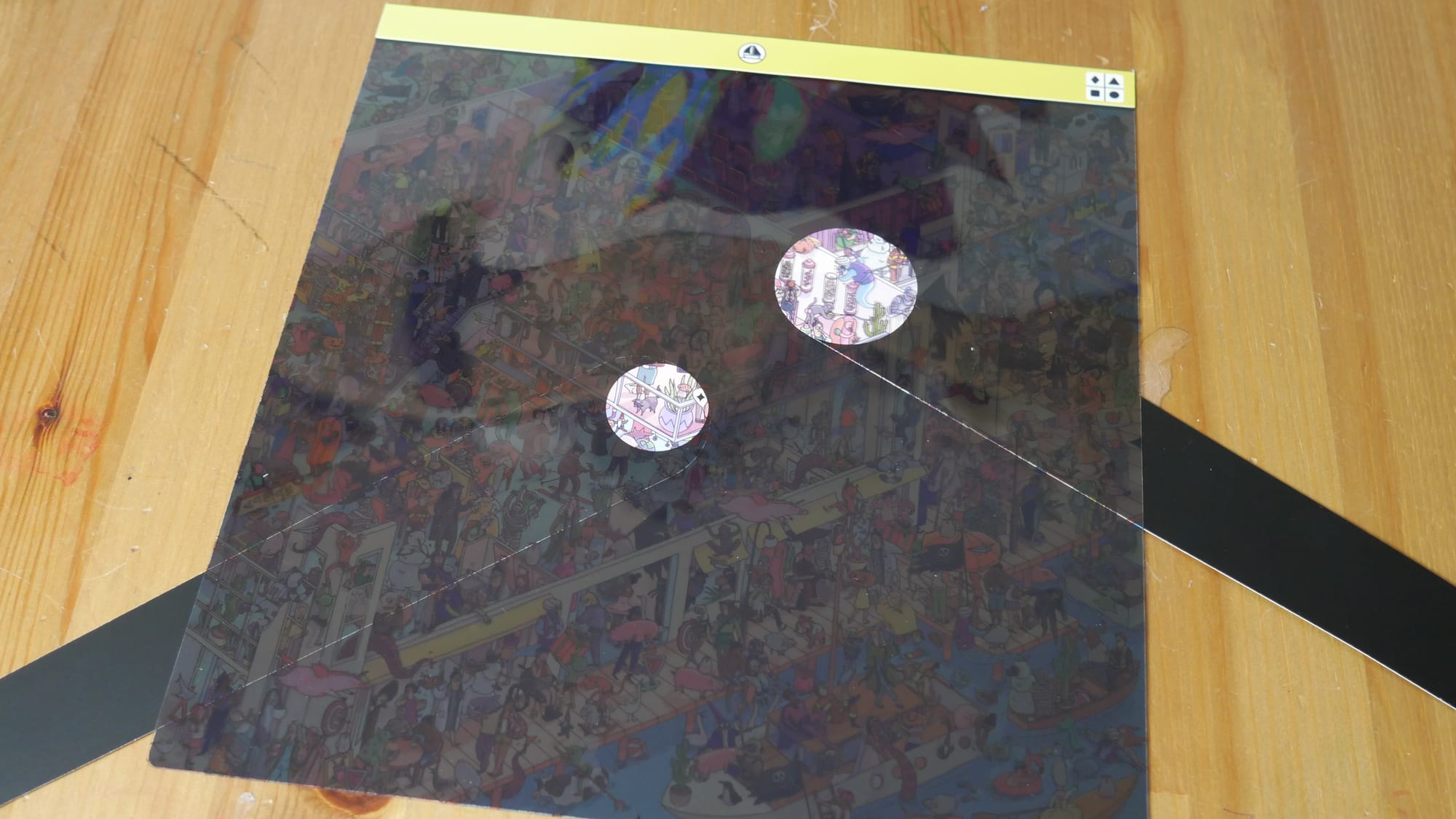 A player's picture covered with a dark film and a small circle illuminated by the white paper flashlight placed under the film.