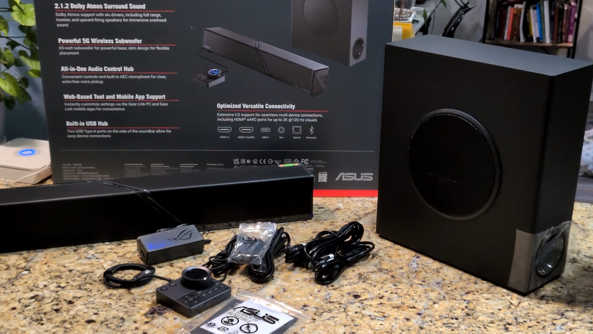 The soundbar, subwoofer, control hub, and power cables are included in this heavy beast's box