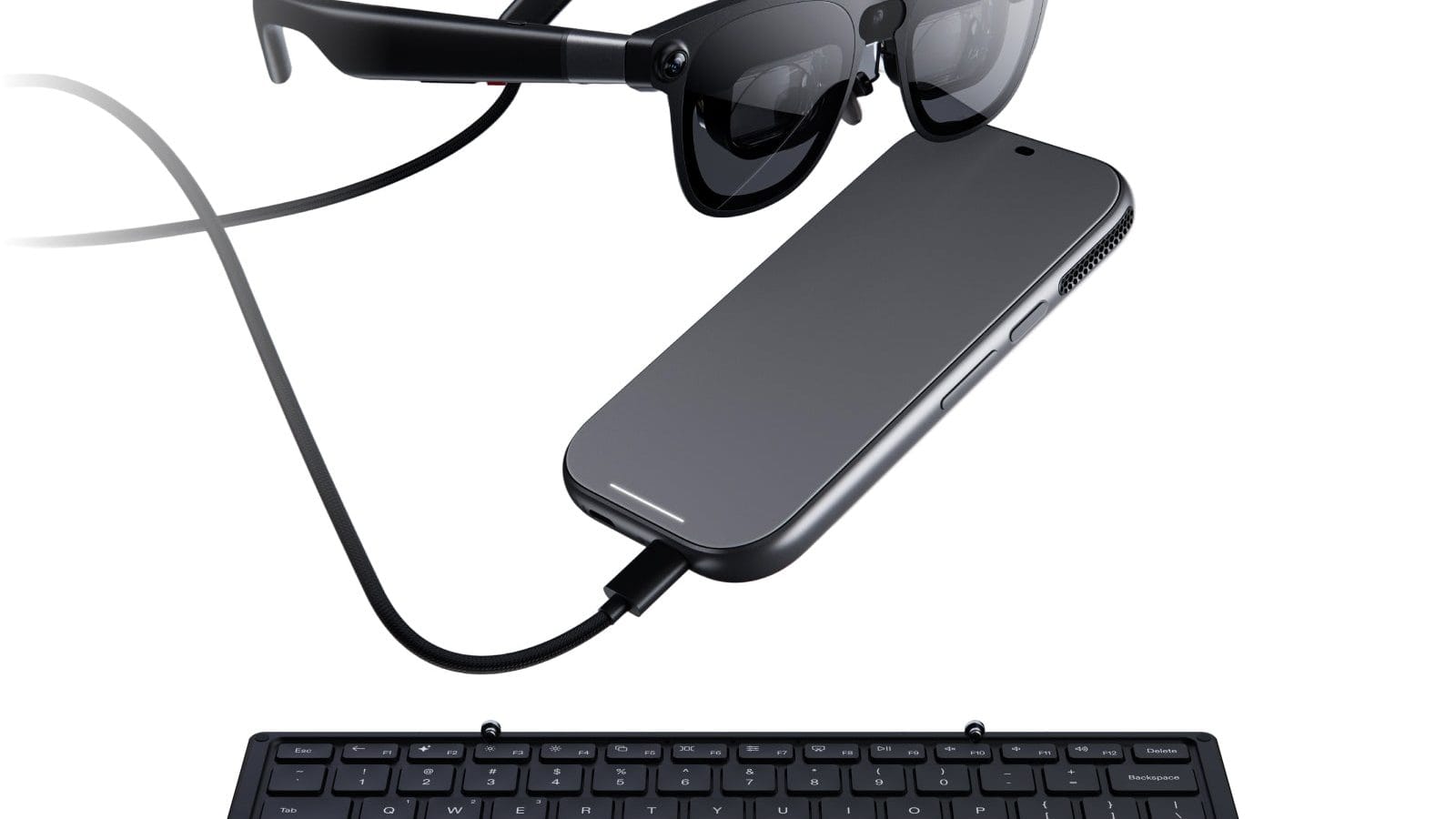 XREAL AURA glasses and compute puck above the foldable wireless portable keyboard