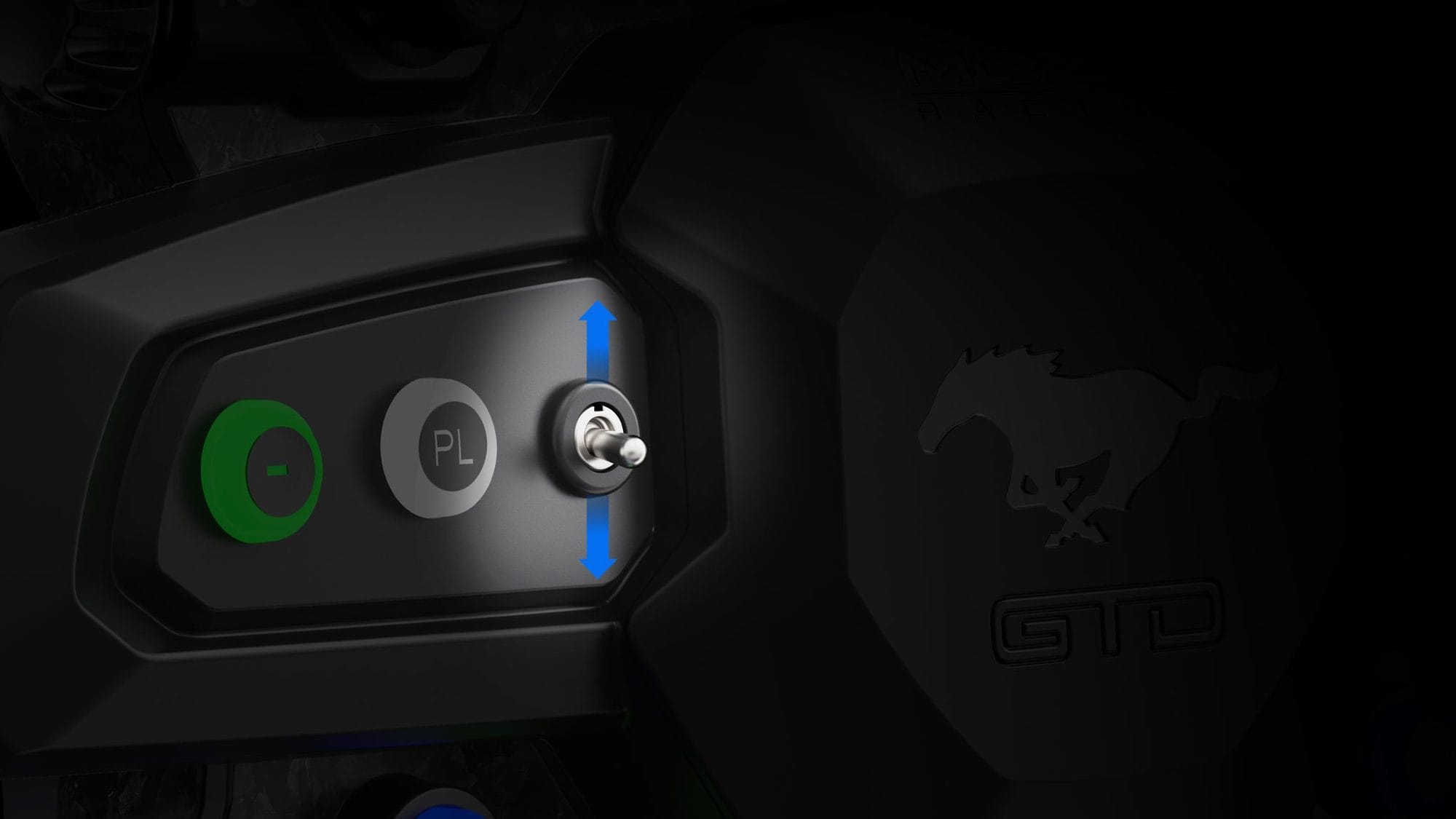 Close-up of the Mustang GTD wheel's toggle switch and backlit buttons beside the pony logo