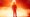 A silloutte of a man in front of an inferno.