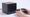Someone holding the Steam Controller in front of the Steam Machine