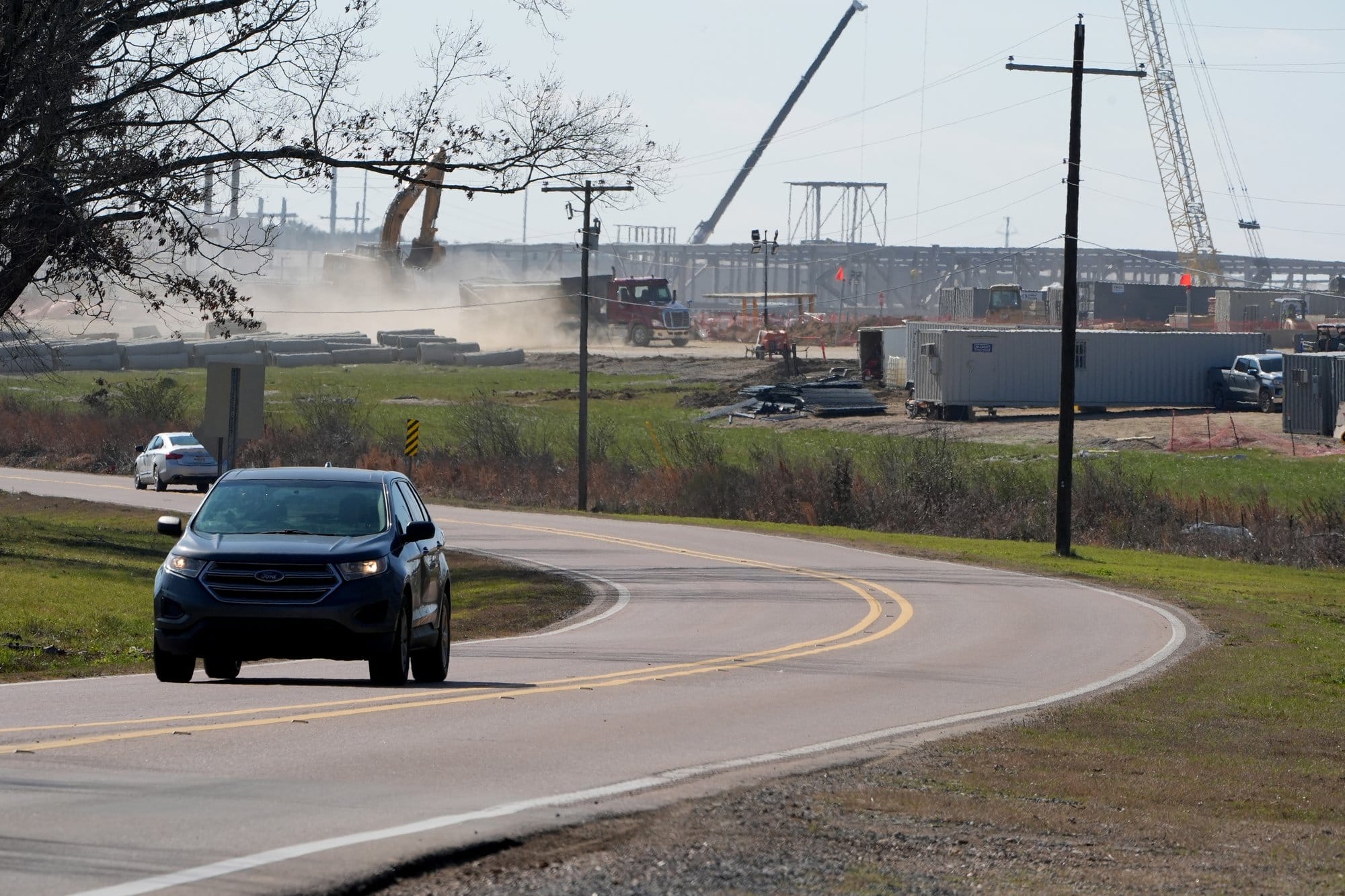 Cars speed past Amazon’s unfinished data center campus in Canton, Miss., on Feb.