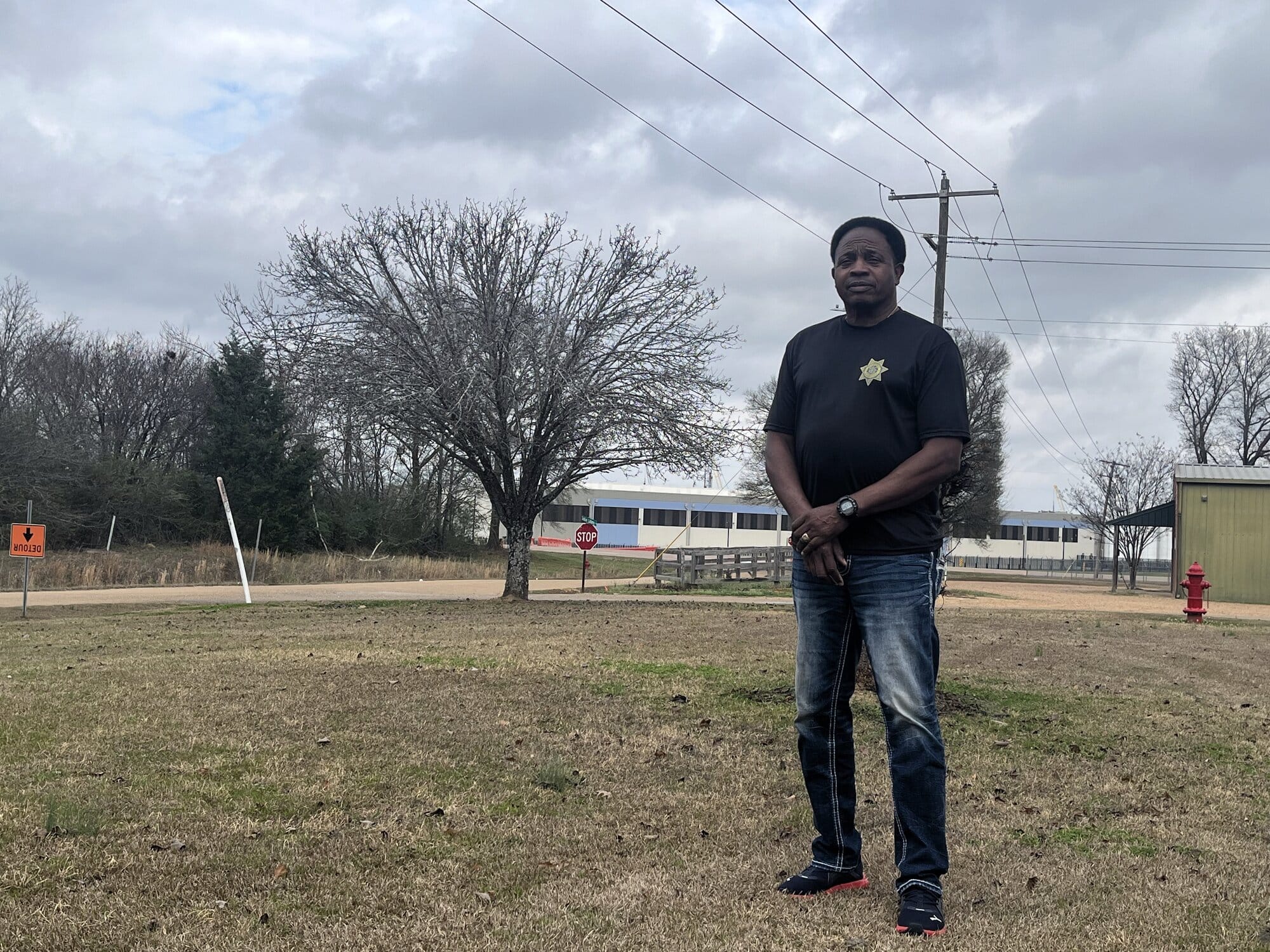 Madison County Constable Johnny Sims stands outside his home down the road from Amazon’s data center campus in Canton,