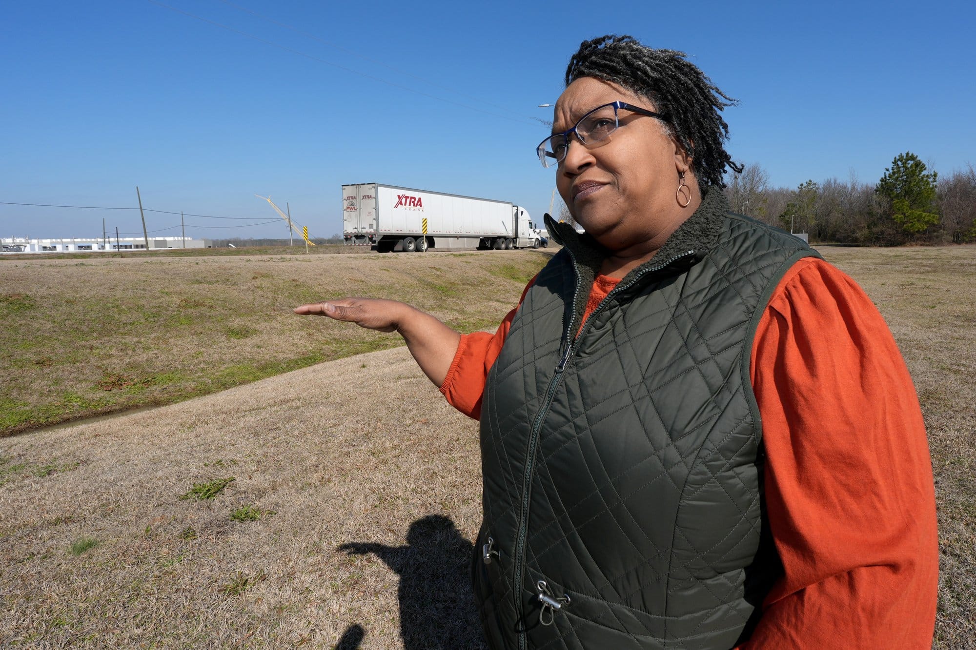 Canton, Miss., Alderwoman Cynthia Allen gestures toward Amazon’s partially completed data center campus across from her home