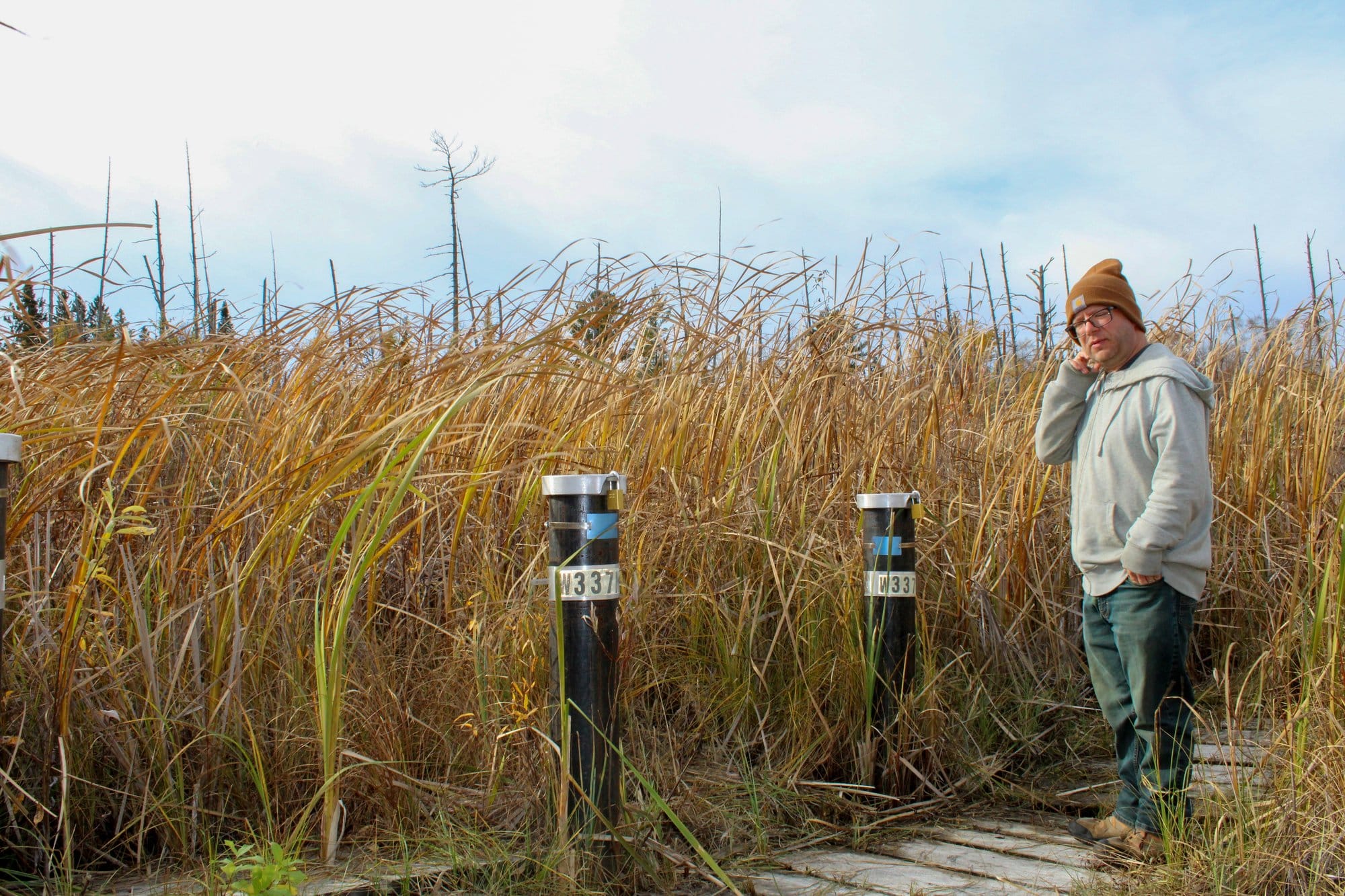 Eric Krumm, Superfund coordinator for the Leech Lake Division of Resource Management, stands next to monitoring wells at Fox