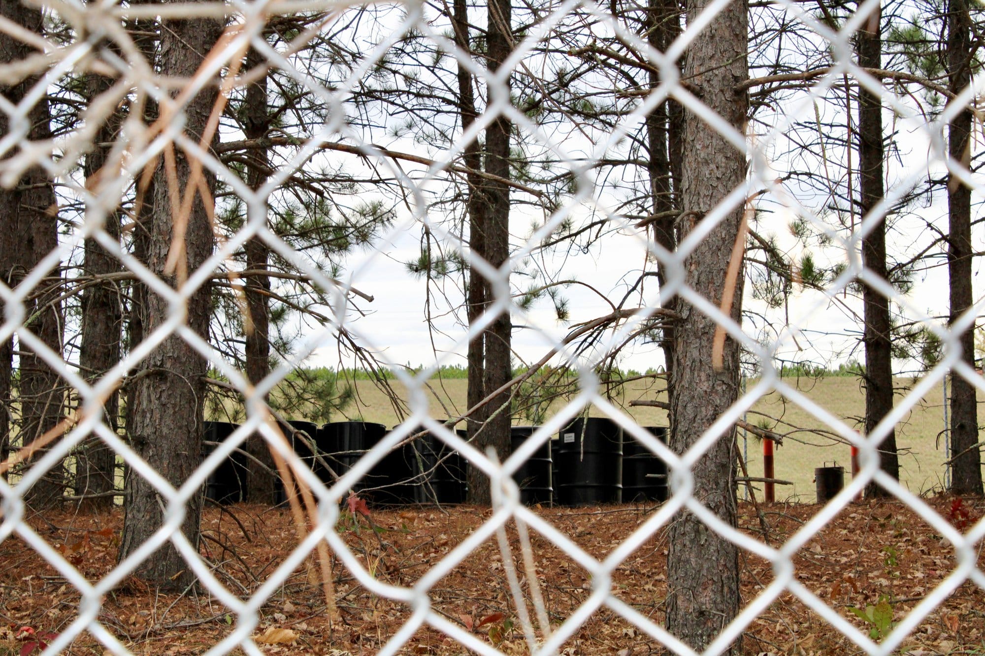 Bins containing hazardous waste sit at the edge of “the vault,” which holds 42,000 cubic yards of contaminated soil and
