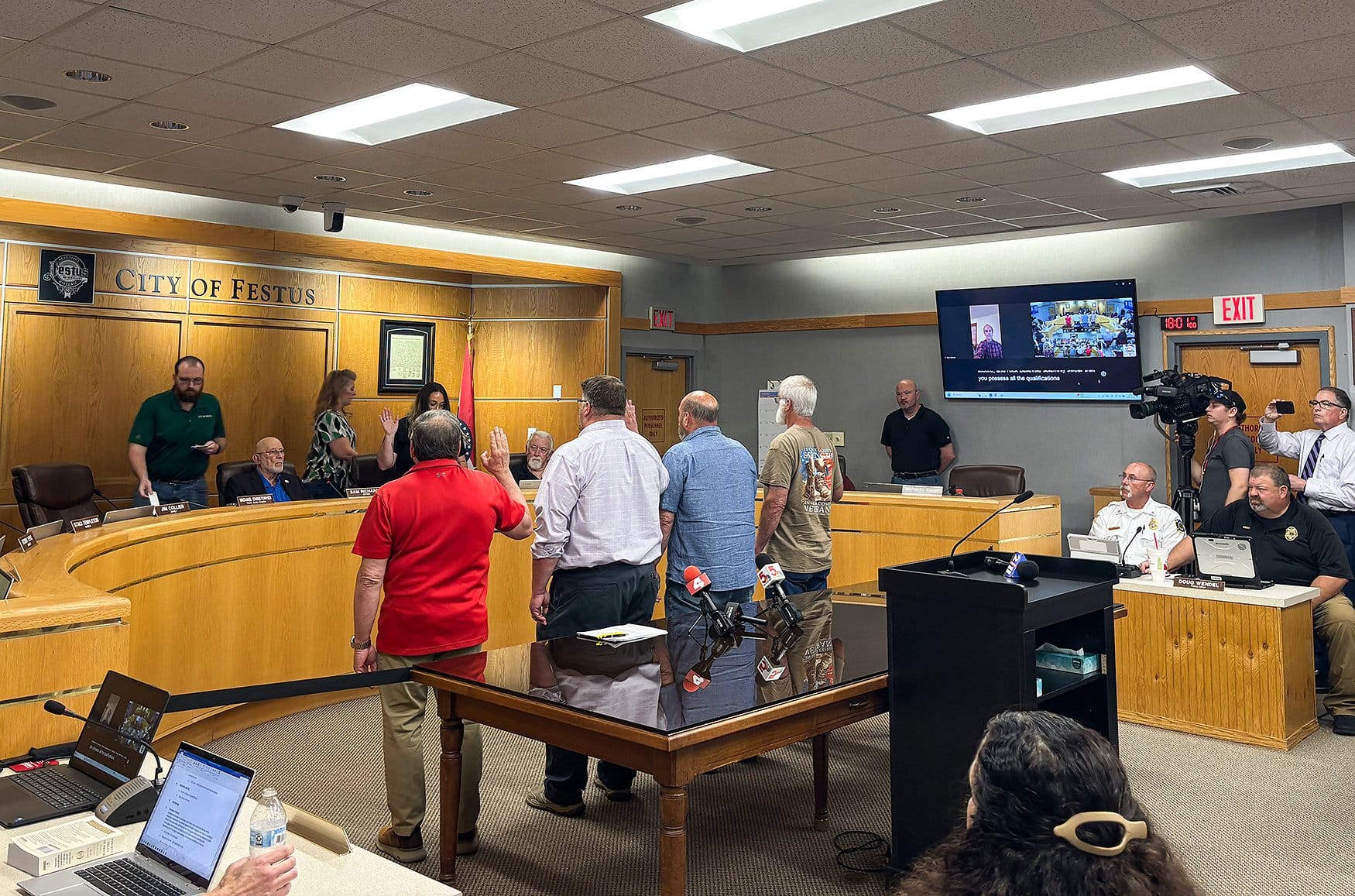 From left to right, Councilmen Rick Belleville, Dan Moore, Allen McCarthy and Karl Weekley hold up their right hands as they