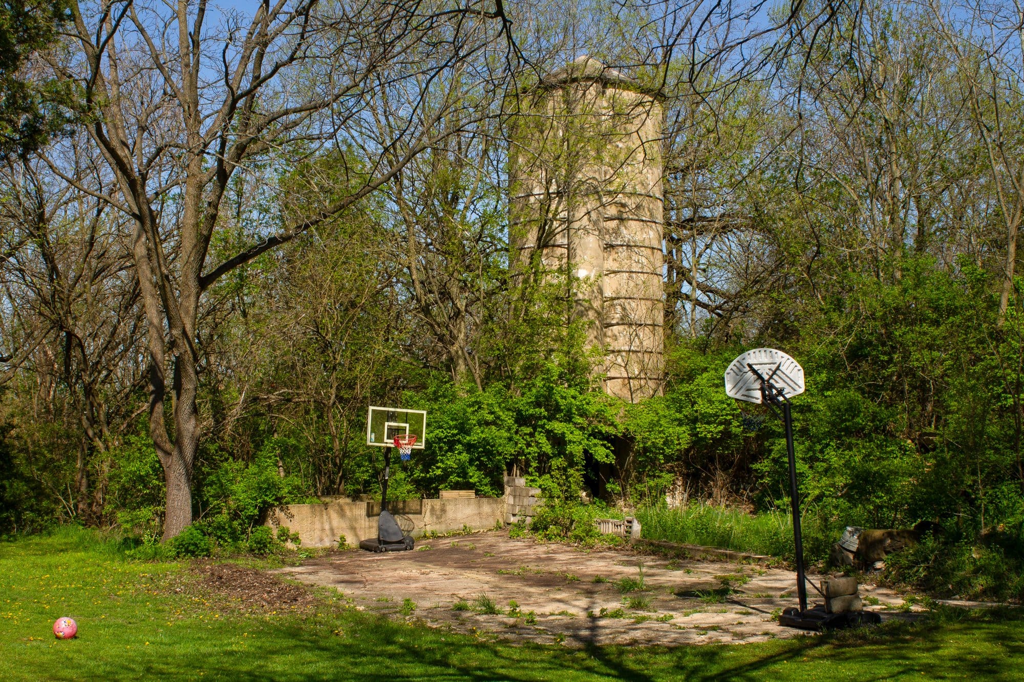 A Frank May silo tucked away behind trees in southern Wisconsin on April 25, 2026.