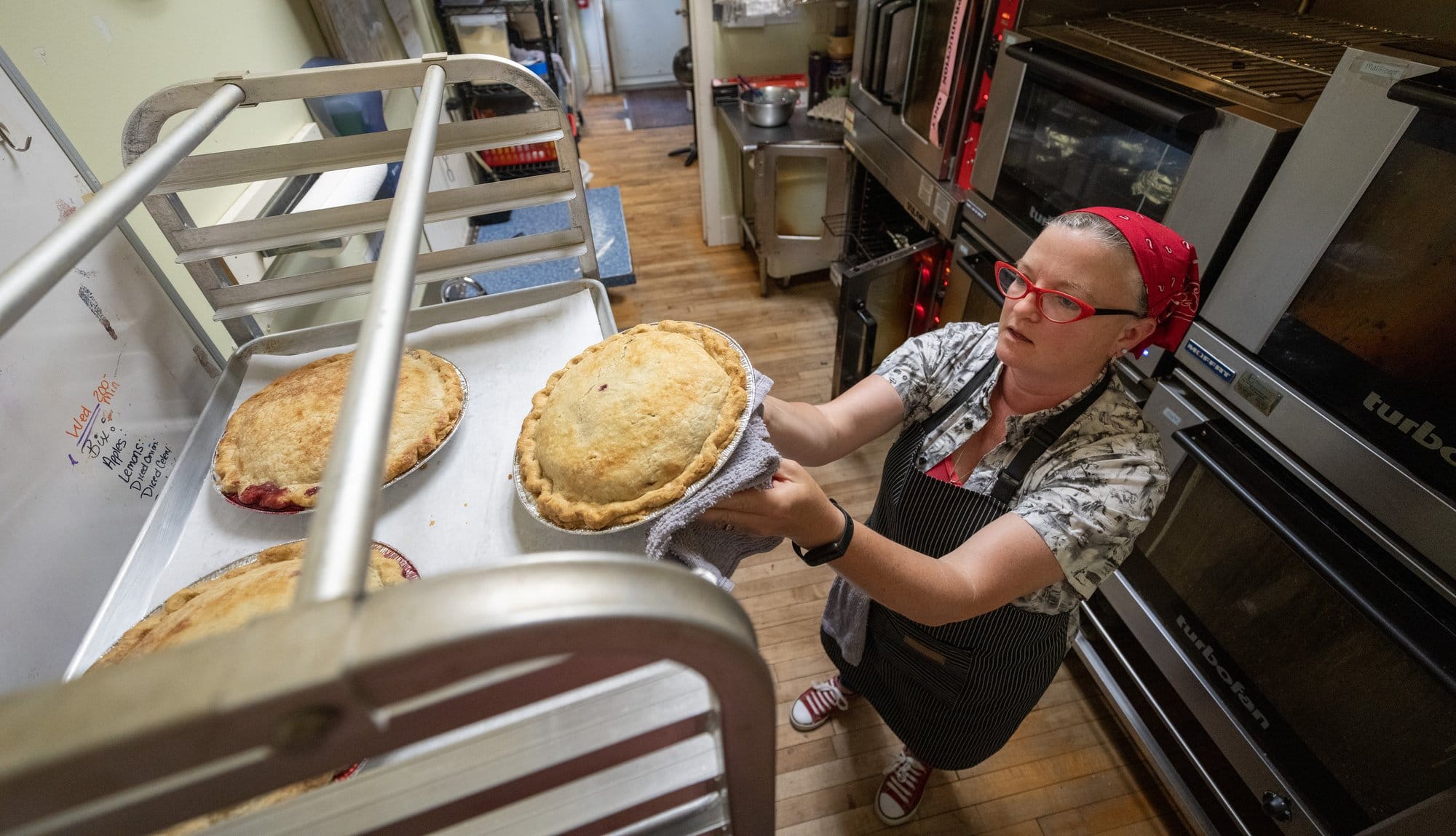 Katie Chalifoux takes pies from the oven Thursday, May 28, 2026, at Stockholm Pie & General Store in Stockholm, Wisconsin.