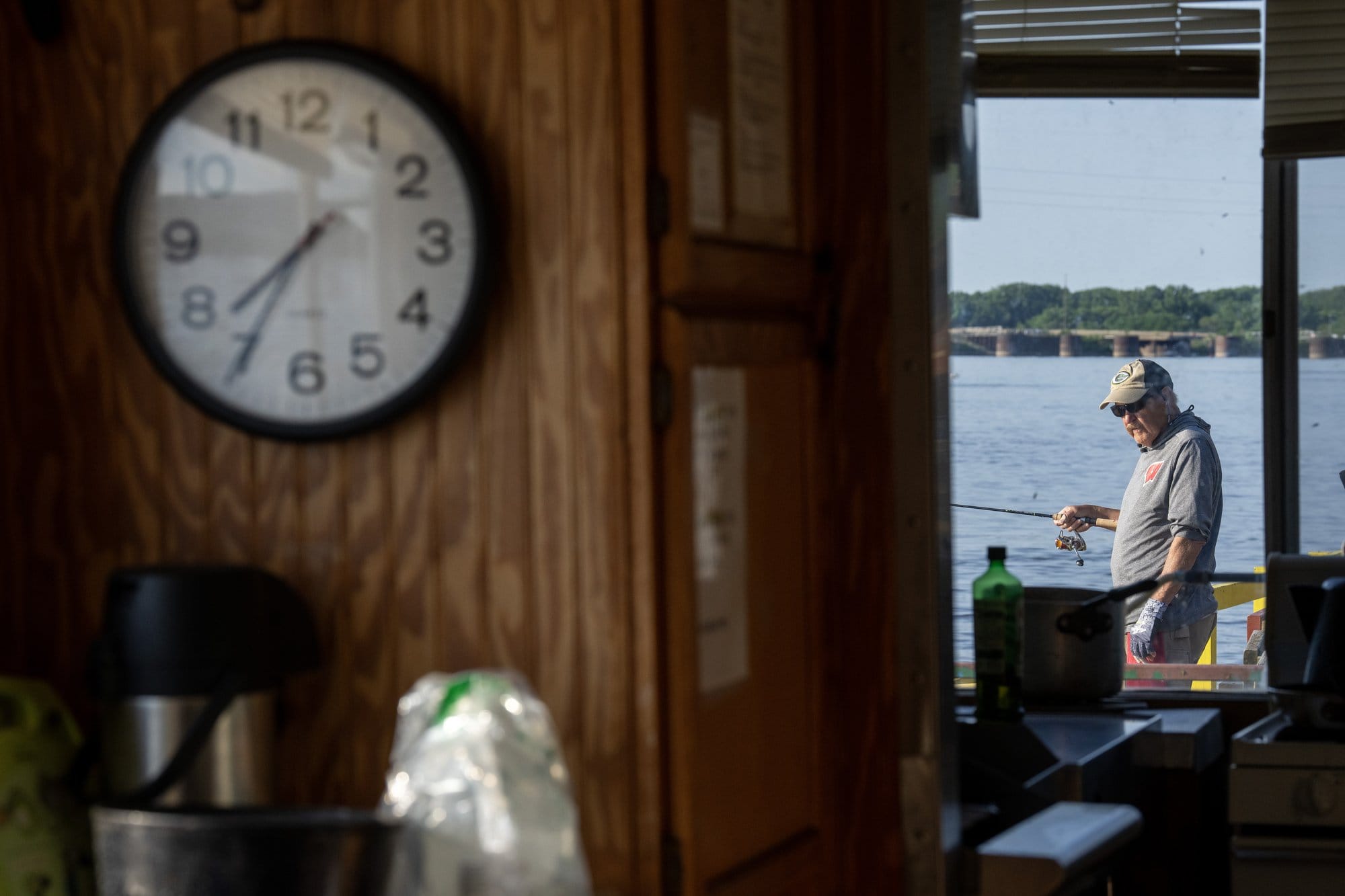 An angler on the first boat of the day out to Clements Fishing Barge tries his luck on the Mississippi River just below Lock