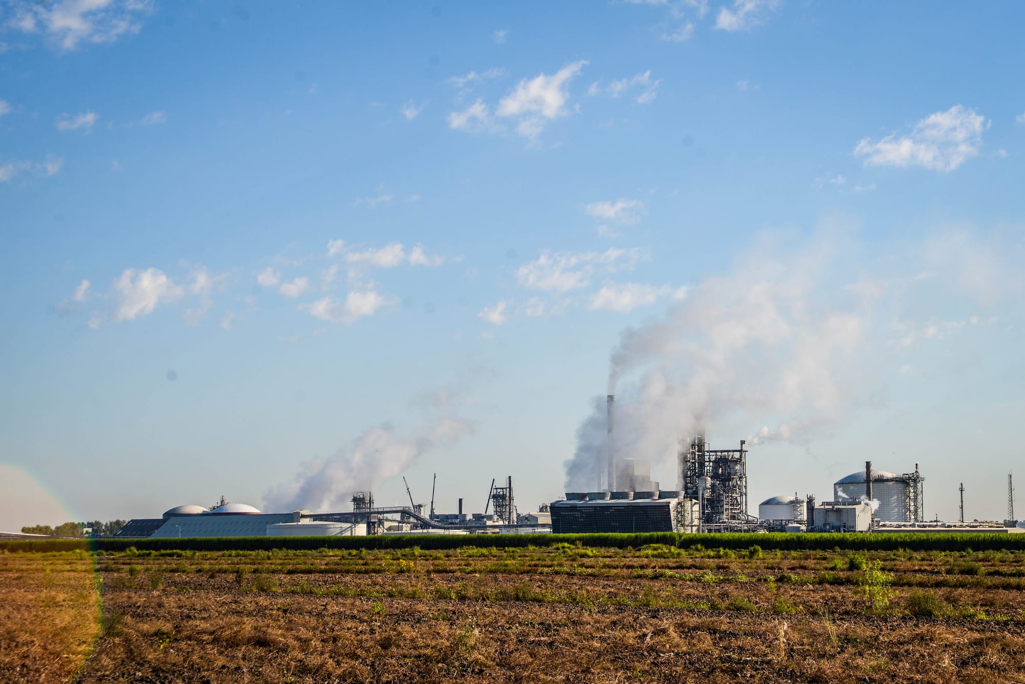 Industrial facilities beside a farm field