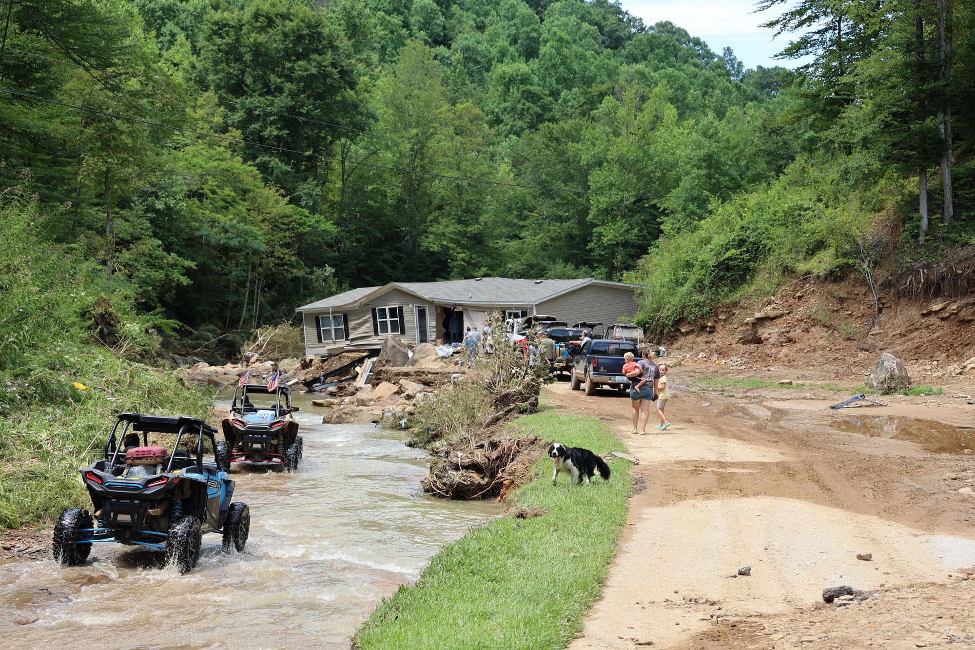ORVs drive through a flooded creek