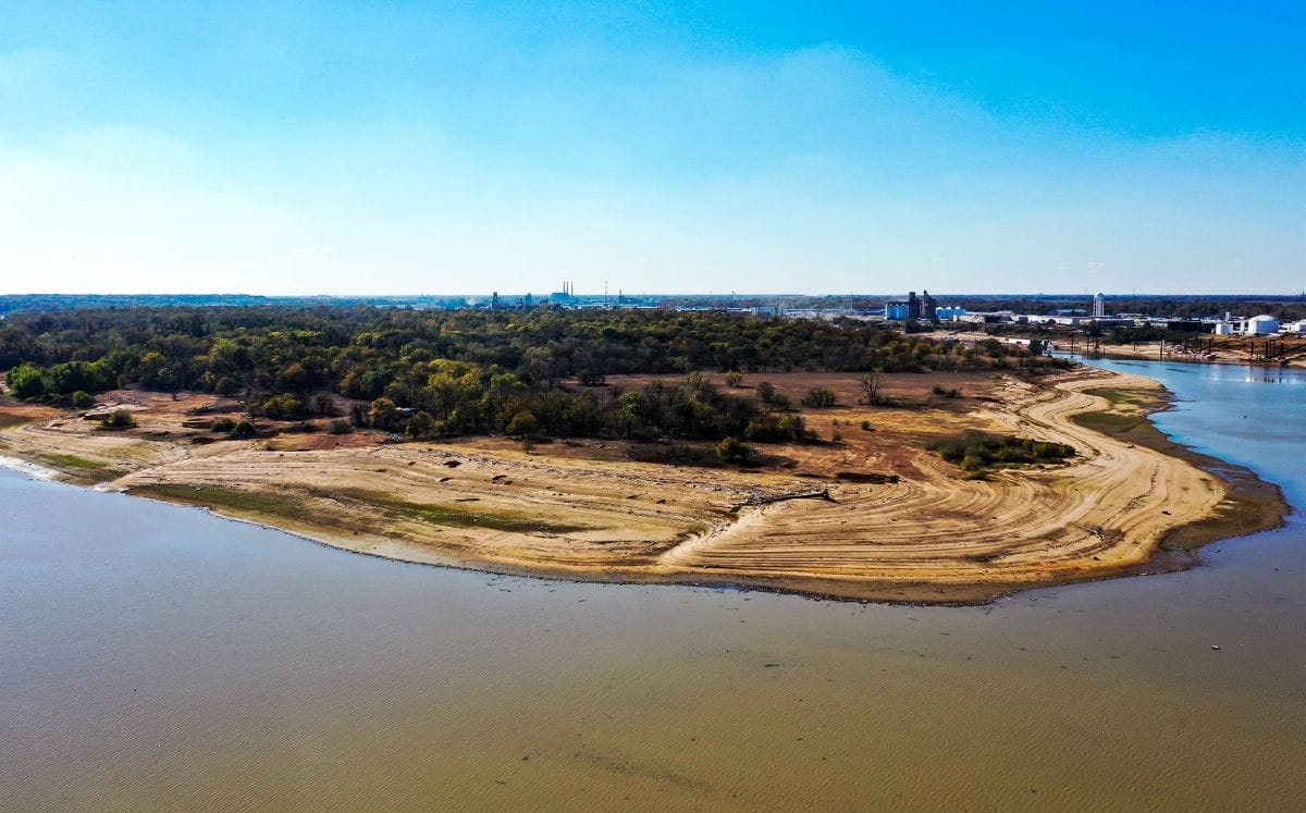 The Mississippi River is low as barges move past
